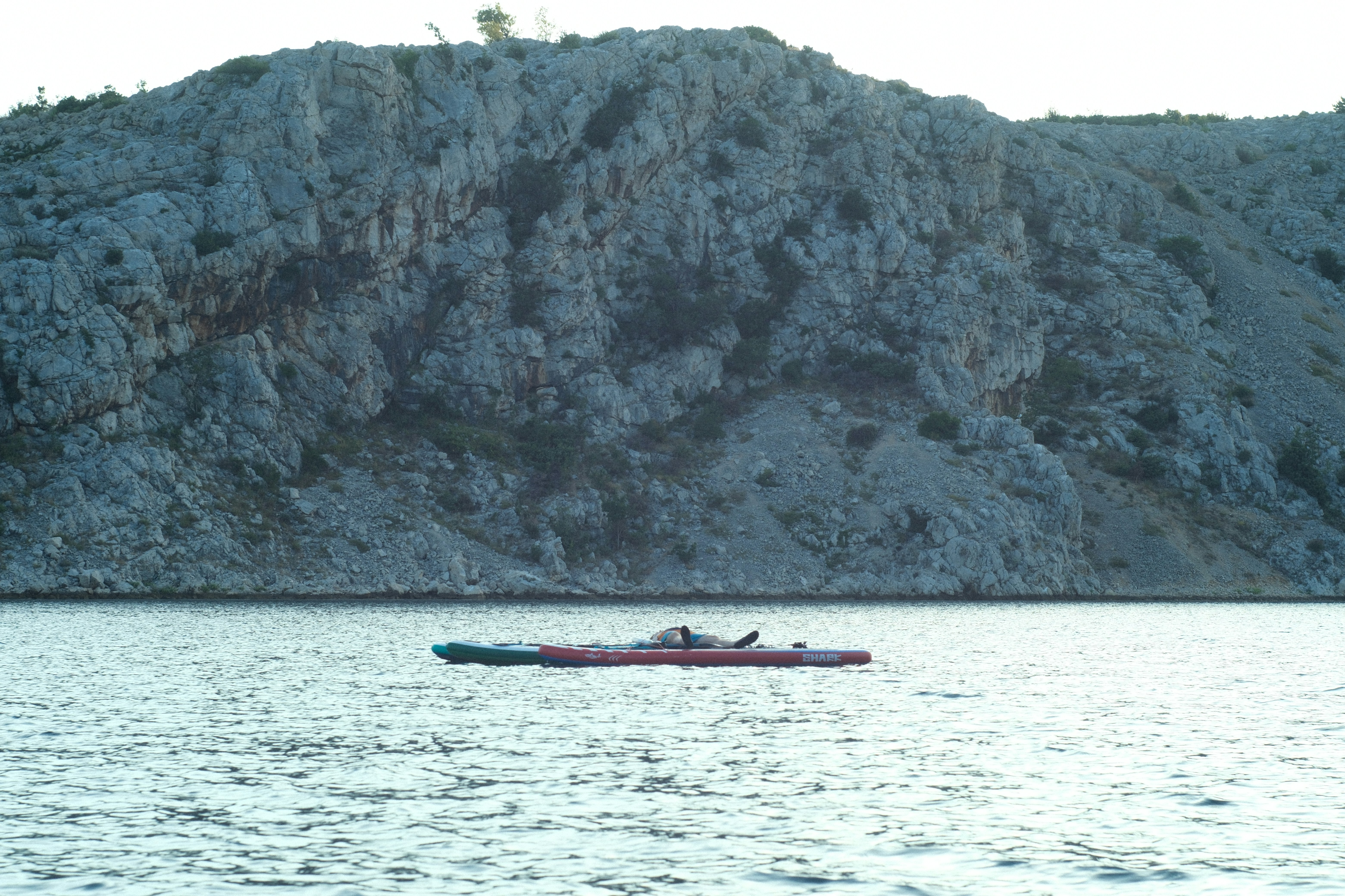 A person in a kayak on a large body of water, 