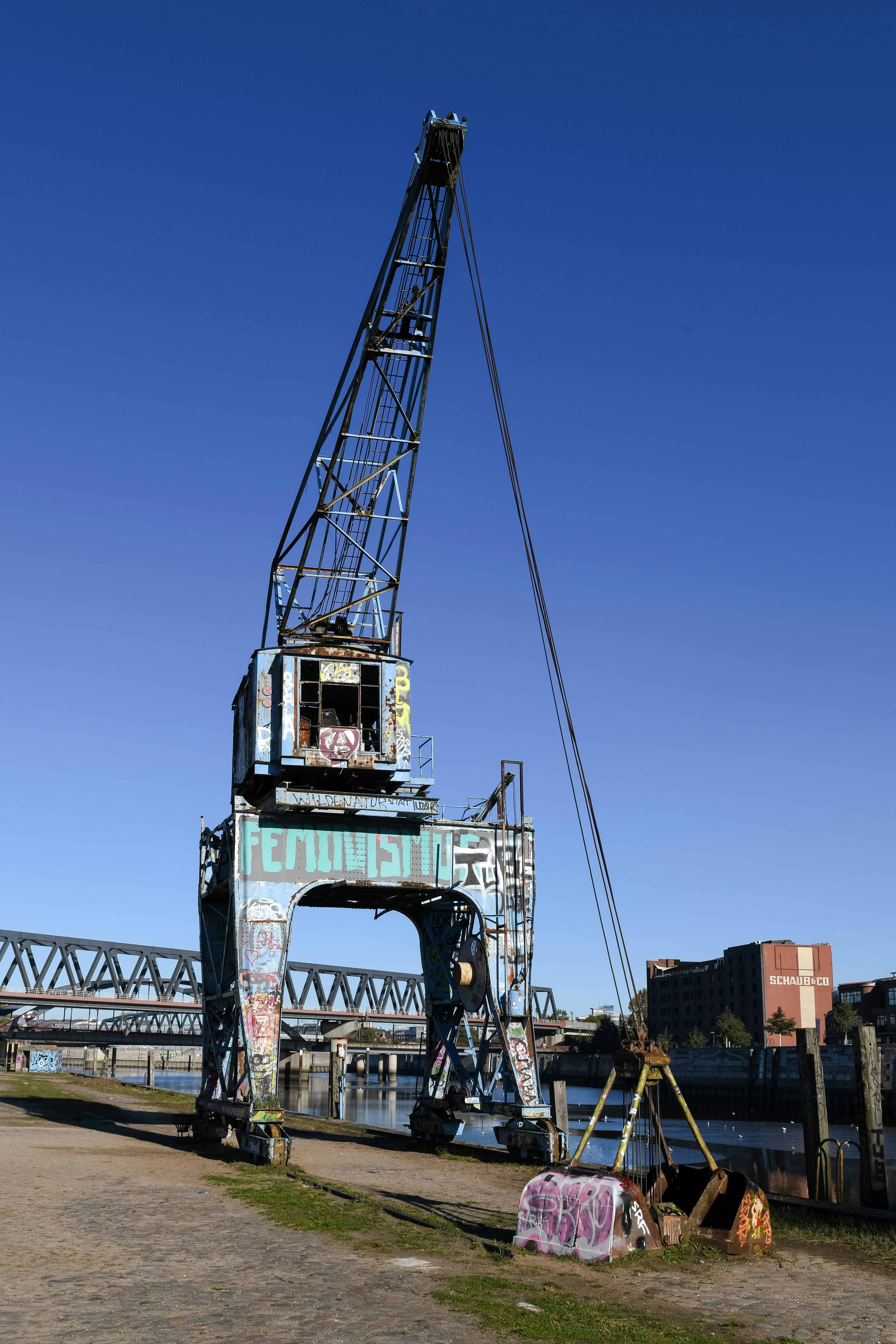 A large crane sitting next to a body of water