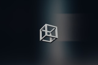 A black and white logo of a cube