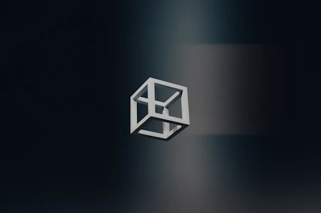 A black and white logo of a cube