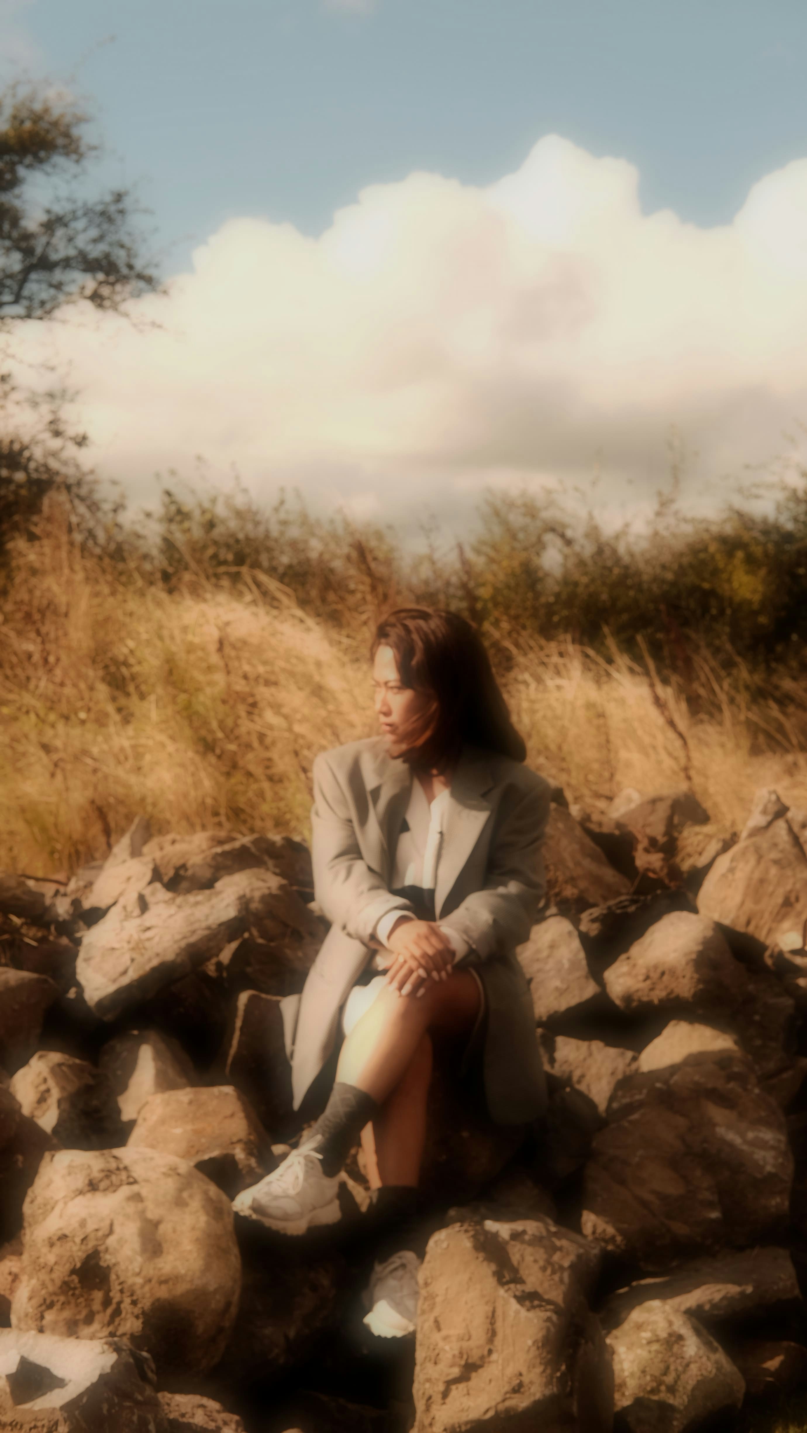 A woman sitting on a pile of rocks