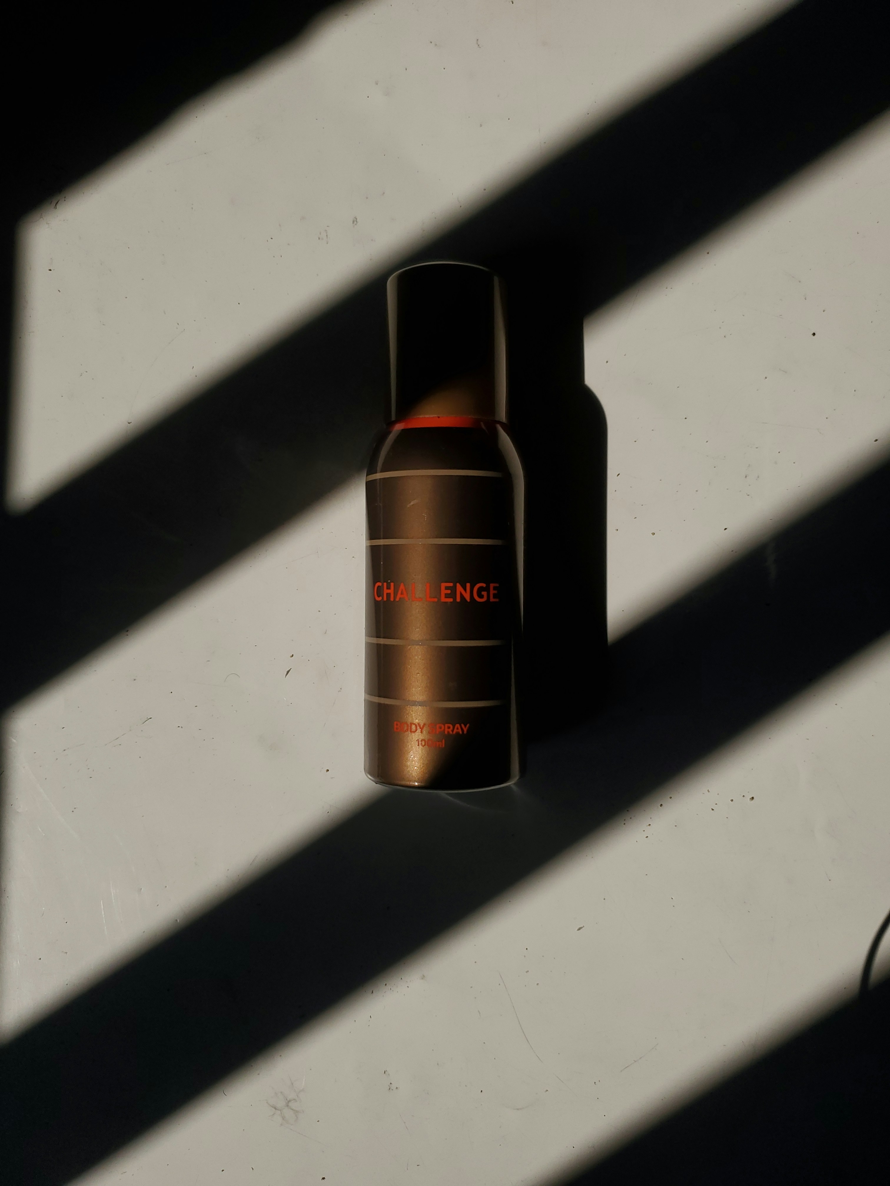 A bottle of perfume sitting on top of a wall