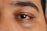 A close up of a man's brown eyes