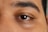 A close up of a man's brown eyes