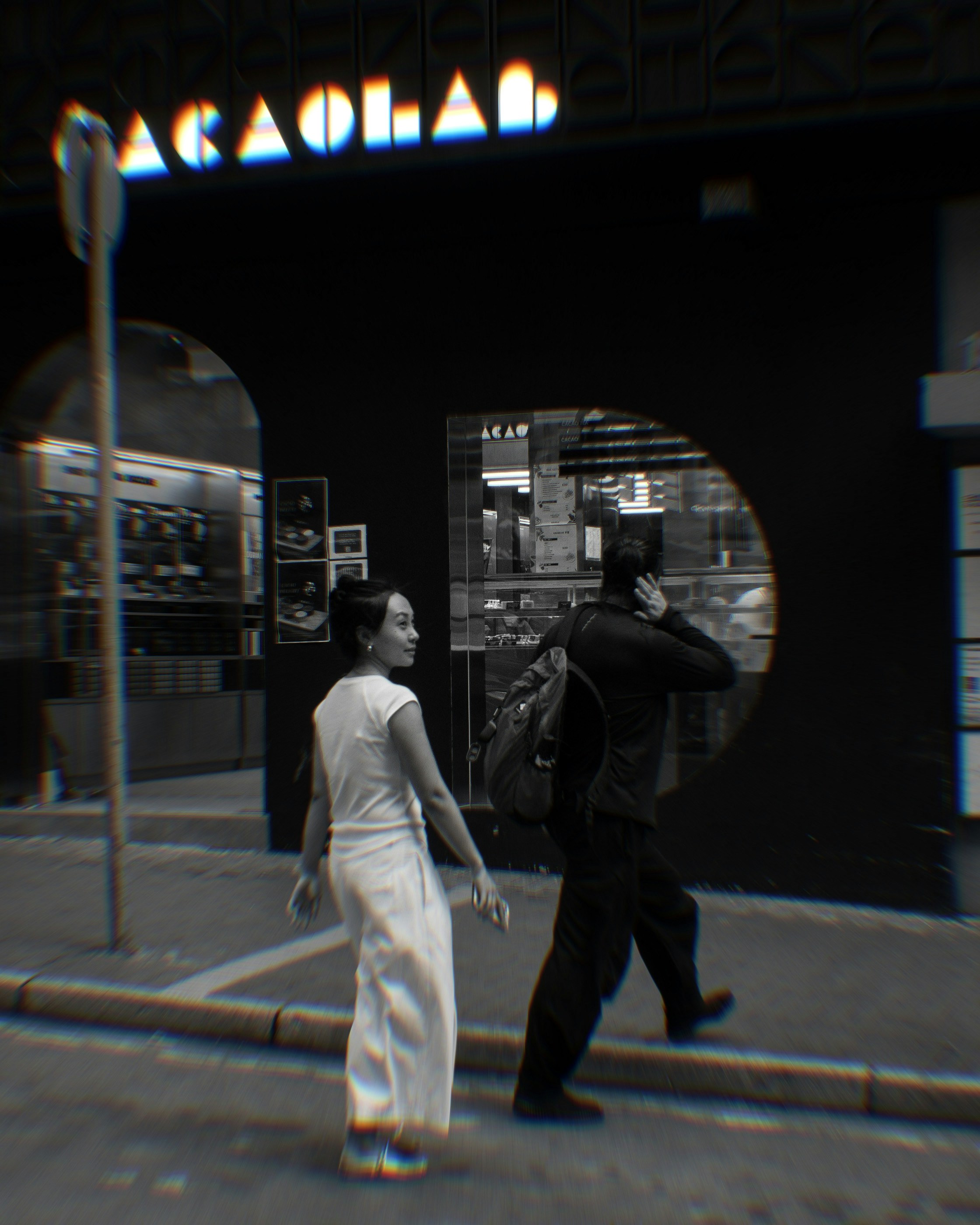 A man and a woman walking down a street