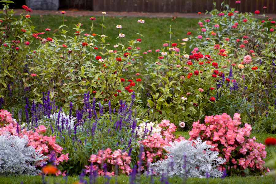 Vibrant flower border landscaping along a residential backyard fence