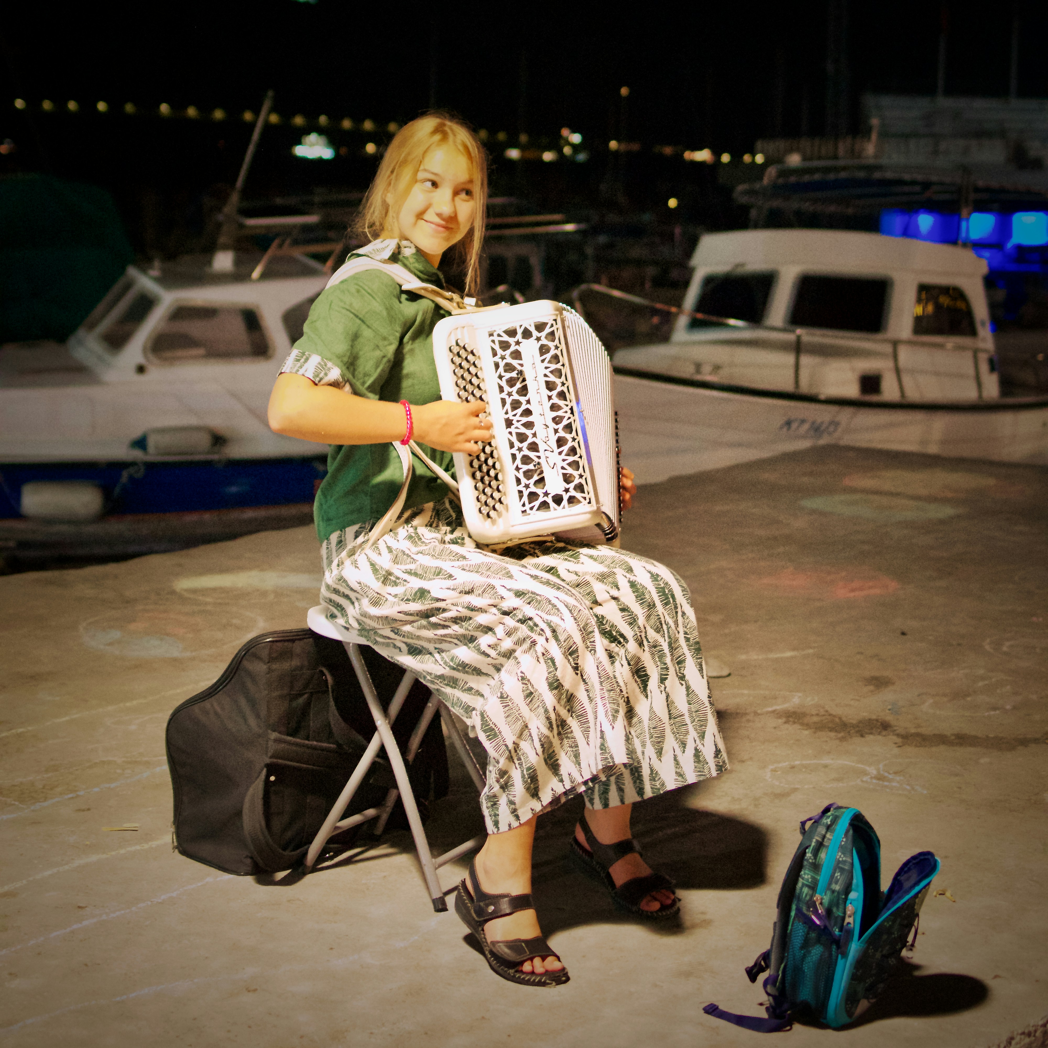 A woman sitting on a chair holding an accordion