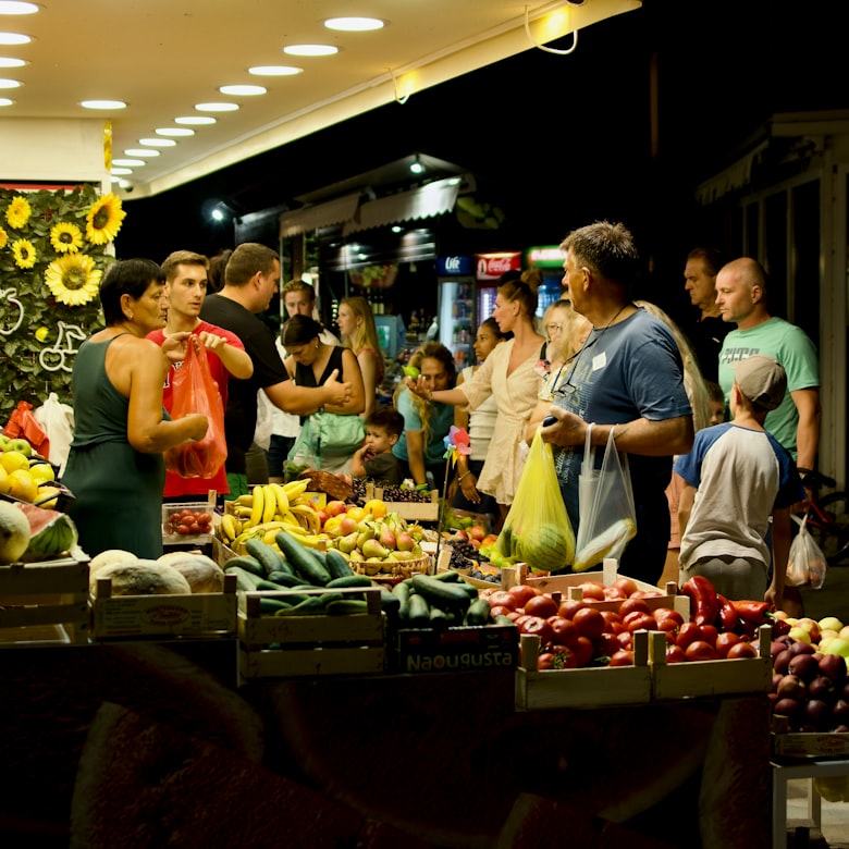 A busy Vietnamese street market with vendors selling fresh produce and local goods