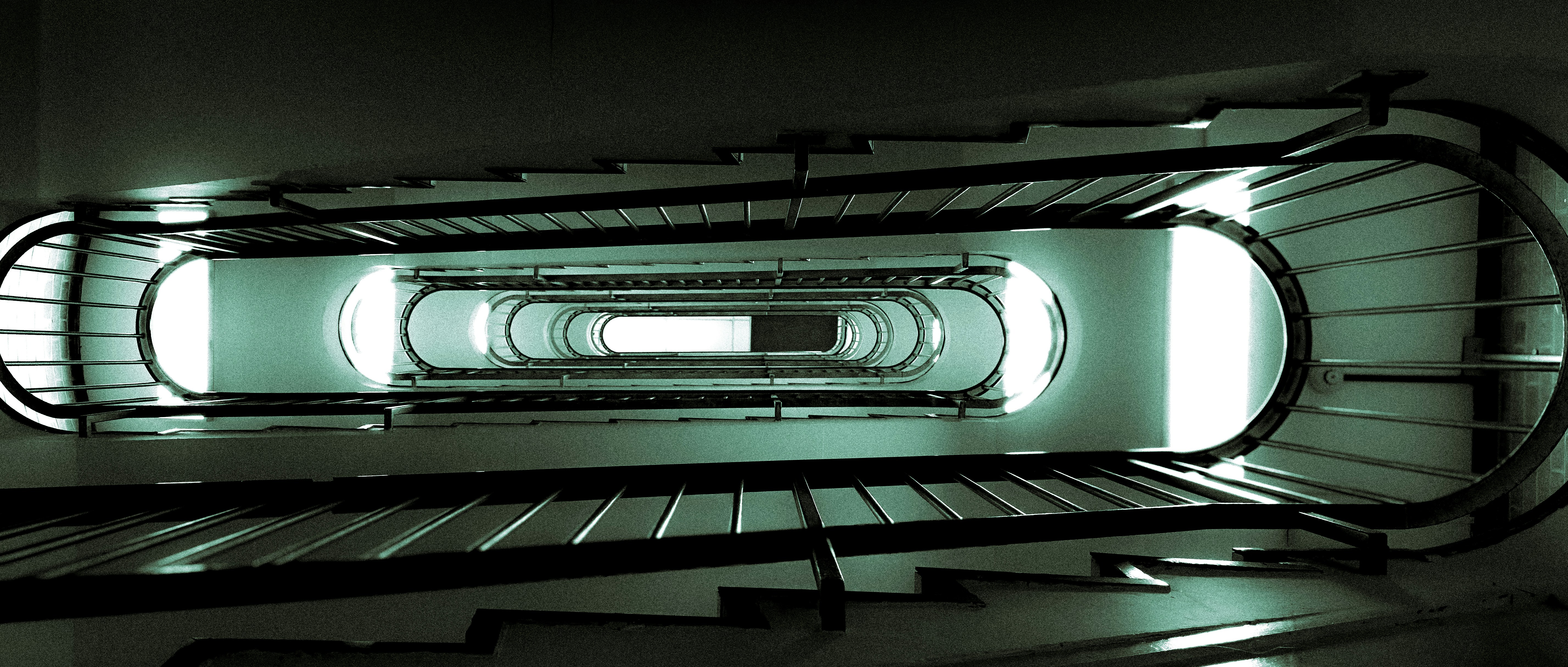 A black and white photo of a spiral staircase
