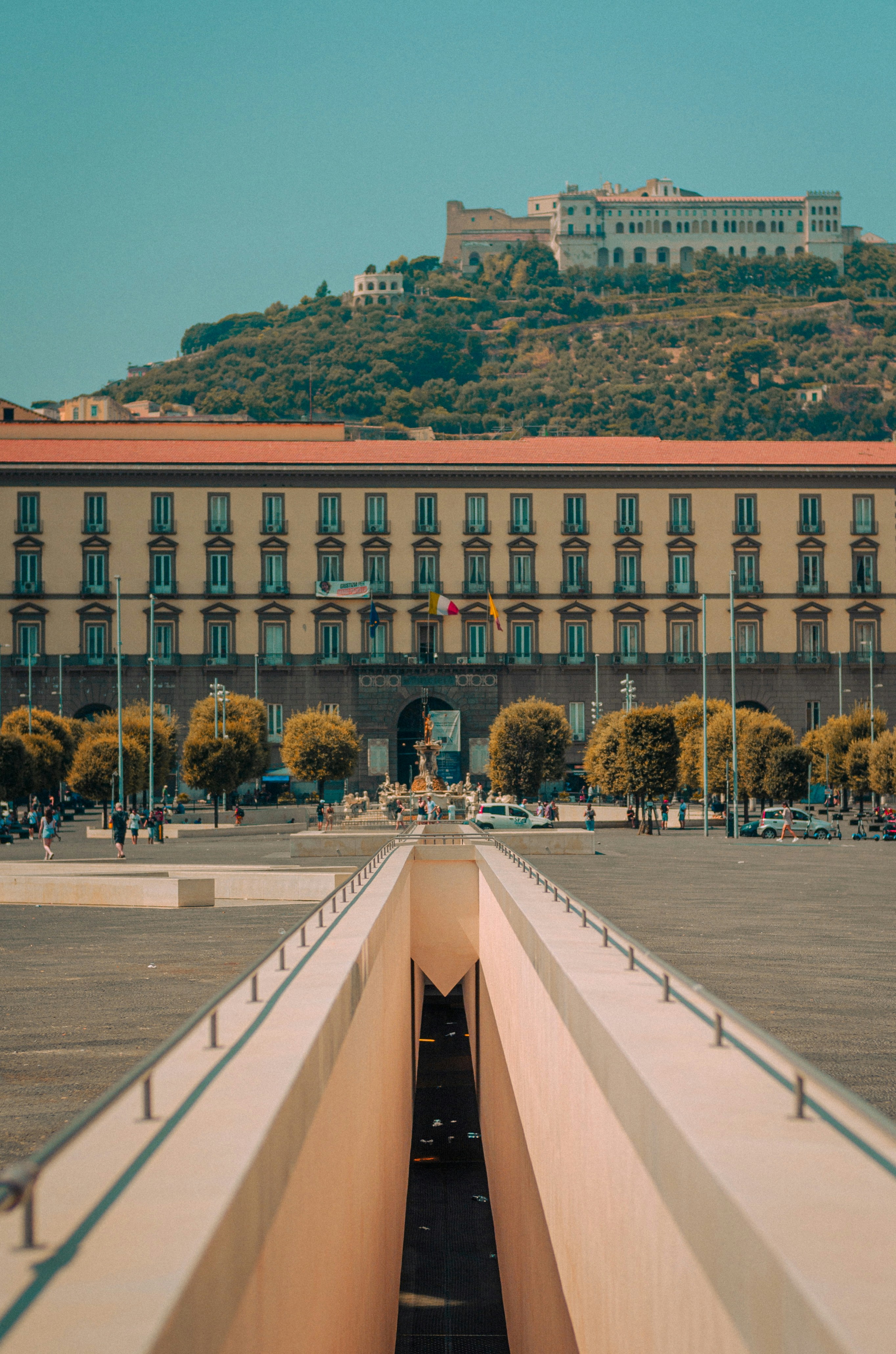 A large building with a hill in the background