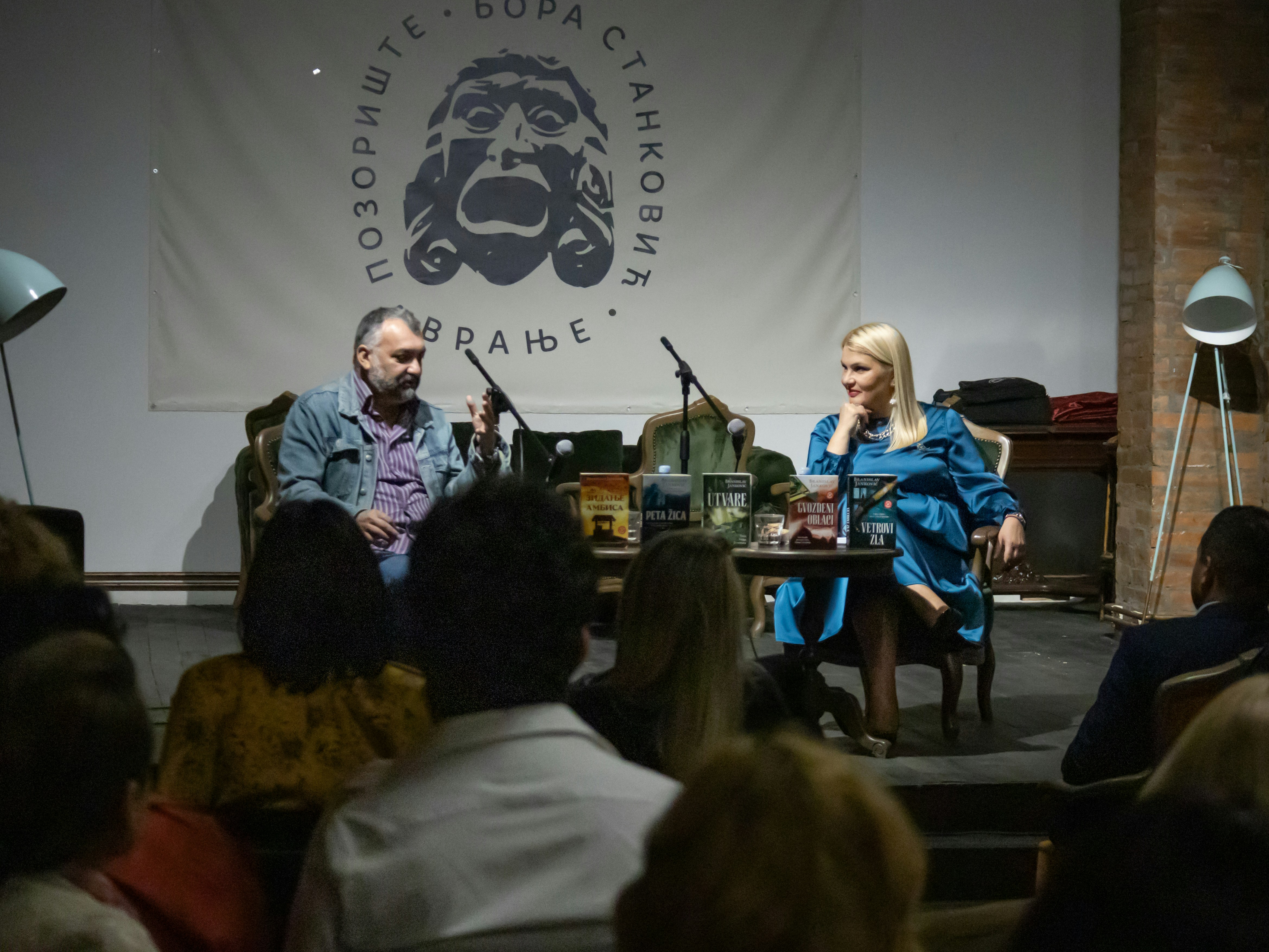 A group of people sitting in front of a crowd