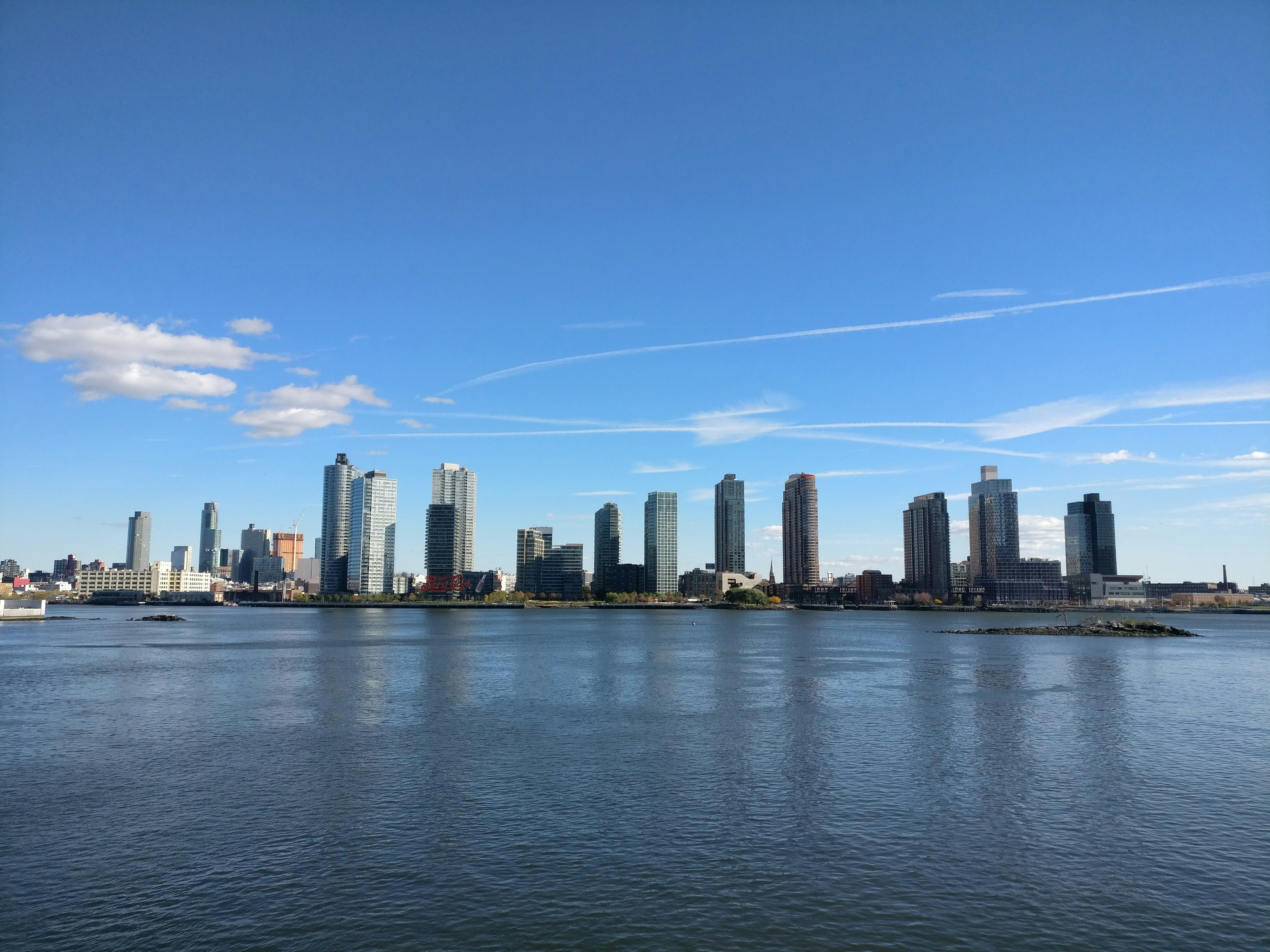 A large body of water with a city in the background, Long Island City, NY, 2016
