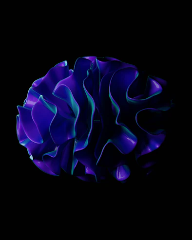 A black background with a blue flower in the center