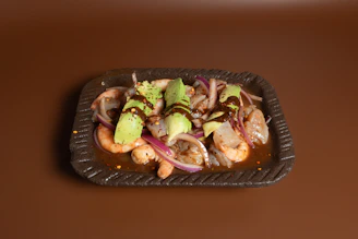 A plate of food on a brown table