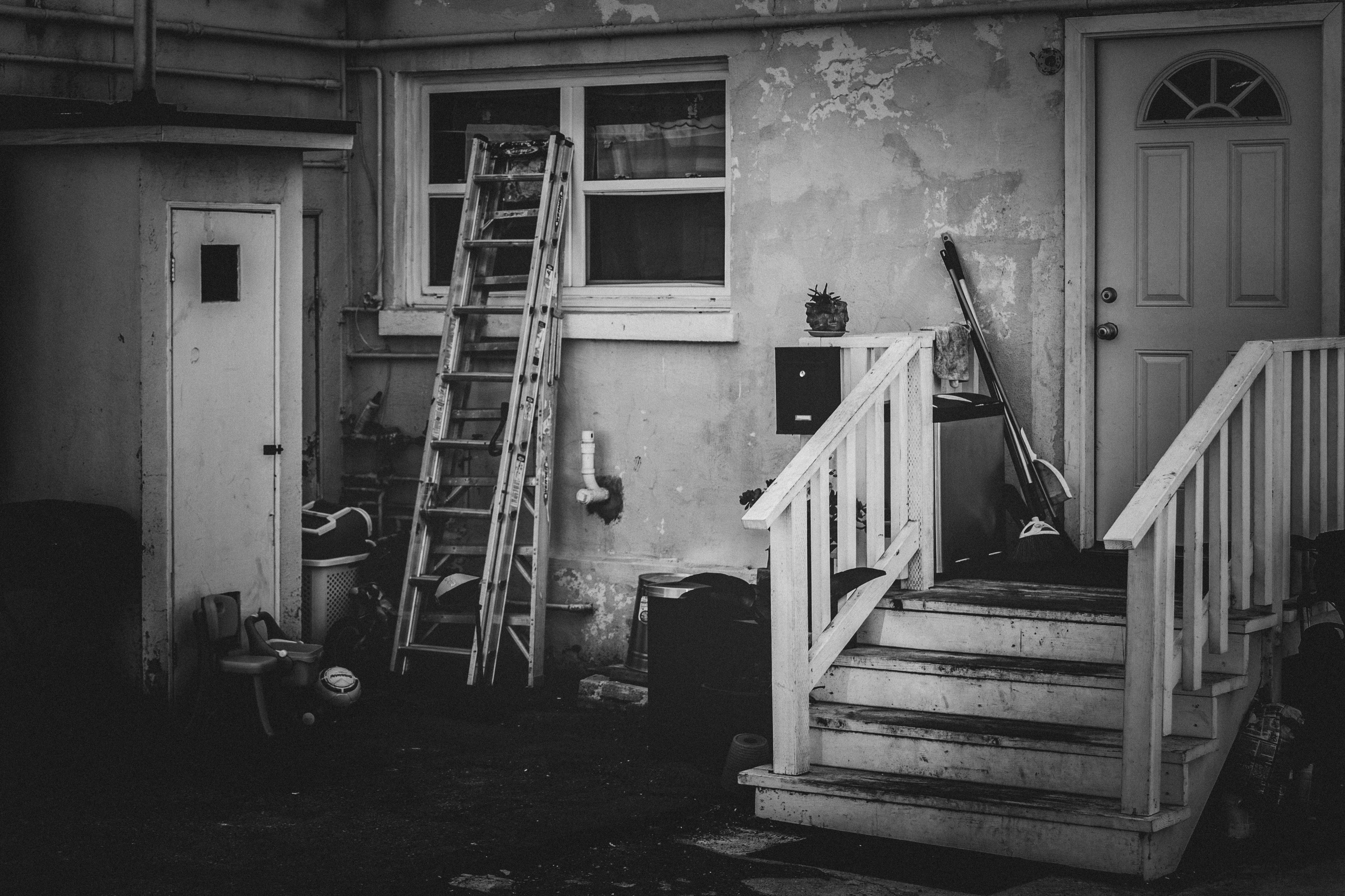 A black and white photo of a door and stairs