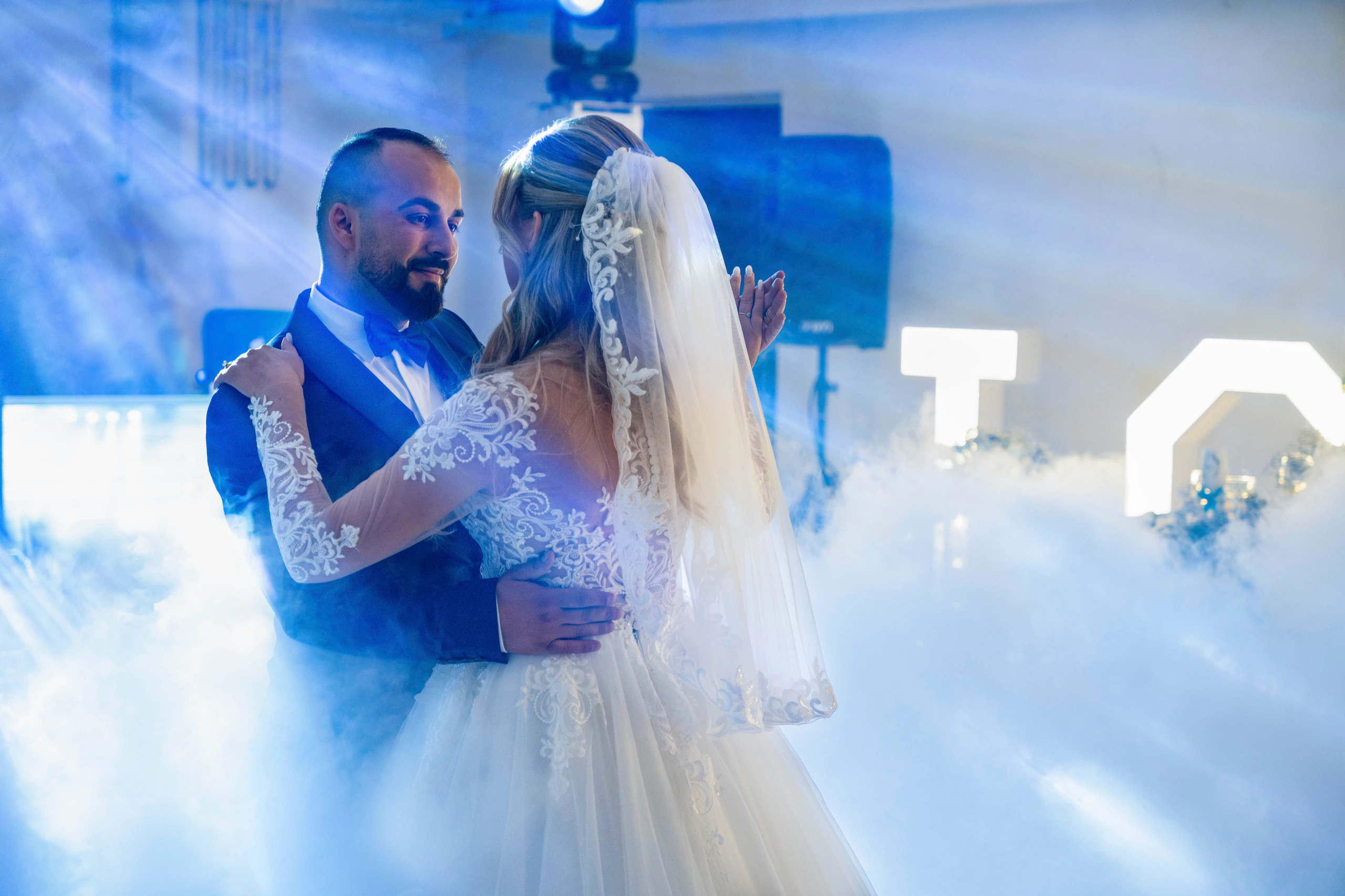 A couple sharing their first dance in a haze of soft light