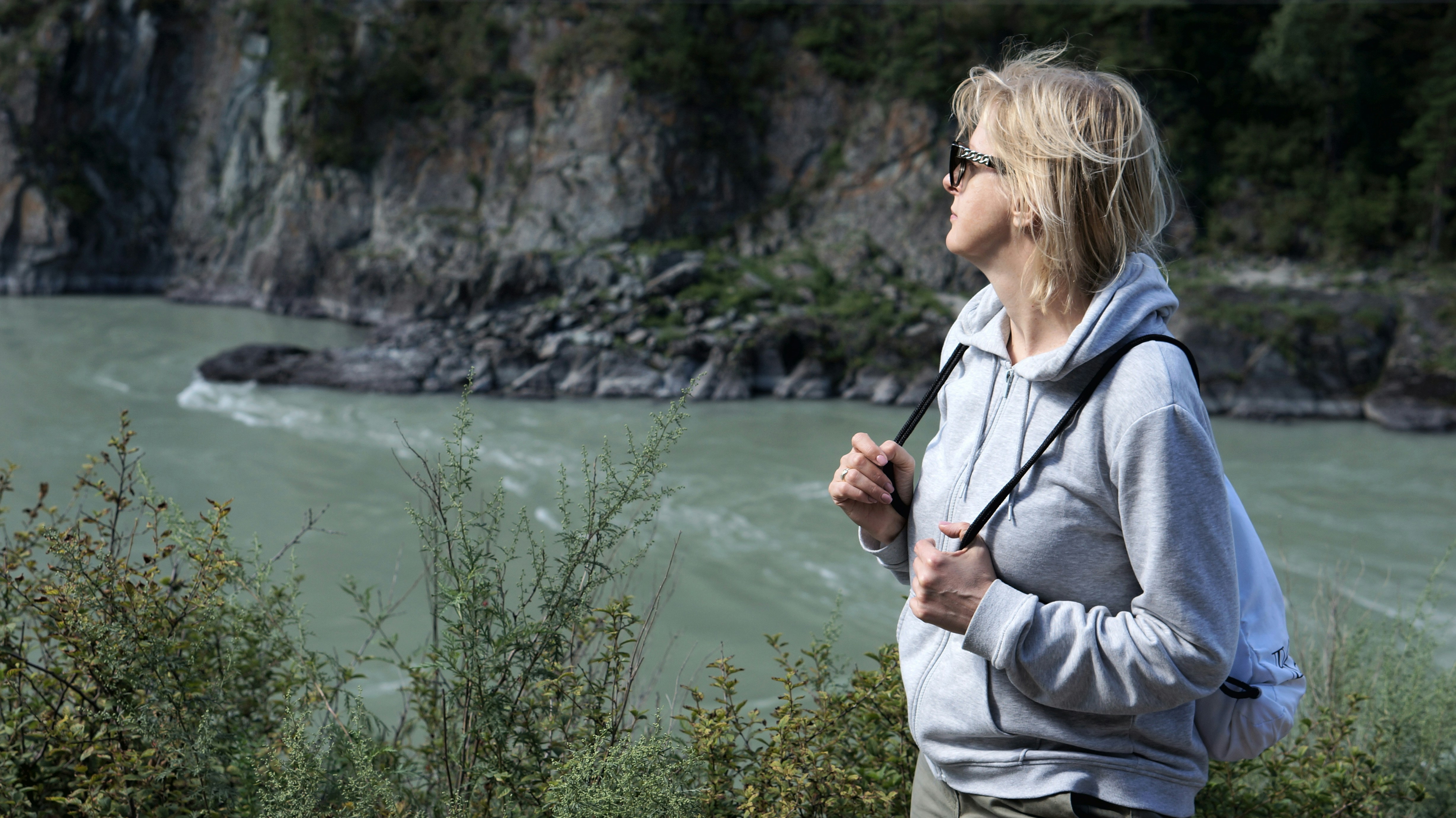 A woman standing in front of a body of water