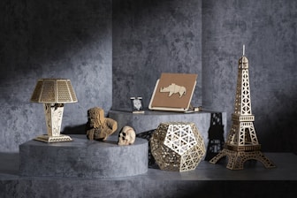 A table topped with a lamp next to a statue of a bear