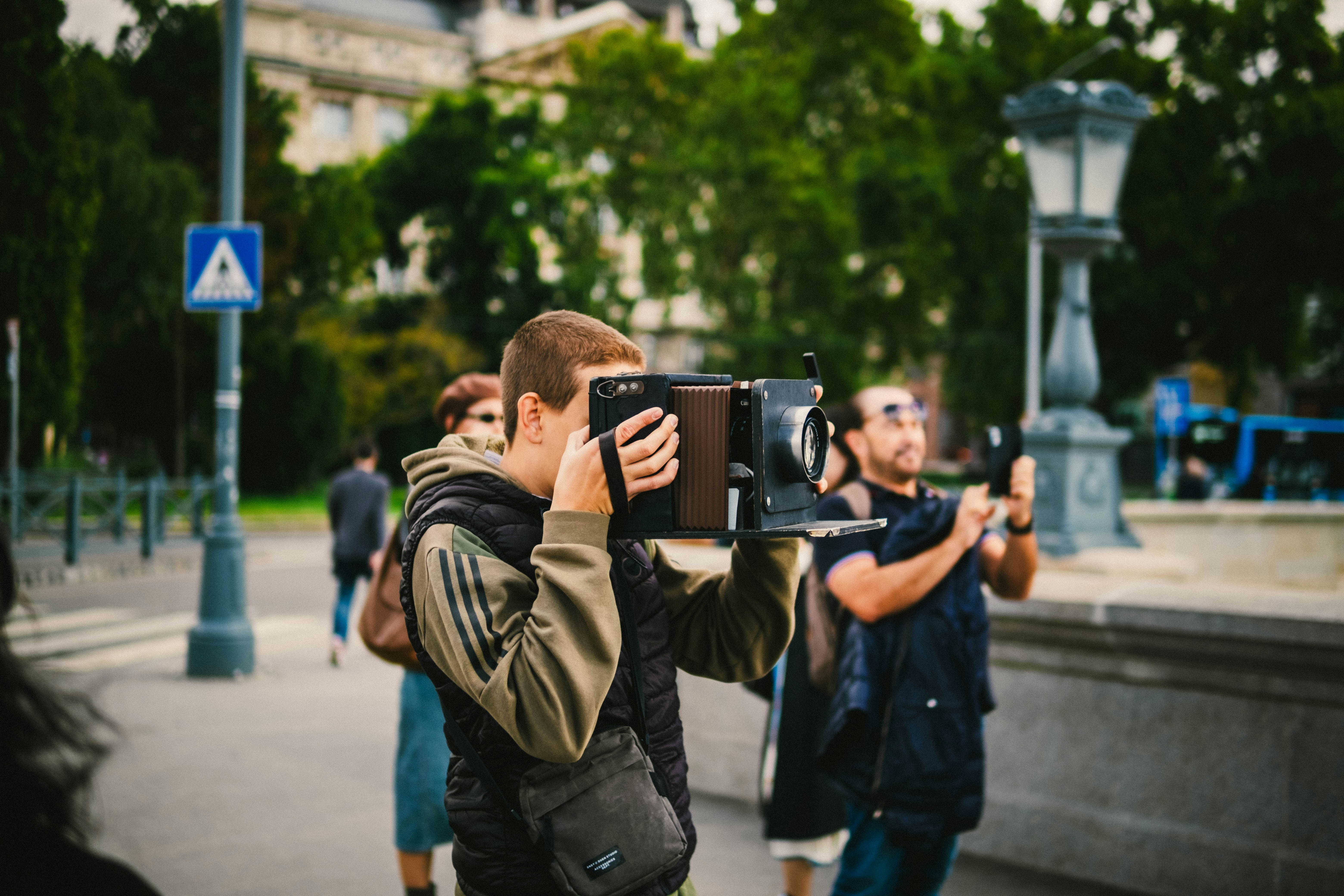 A man taking a picture of another man with a camera