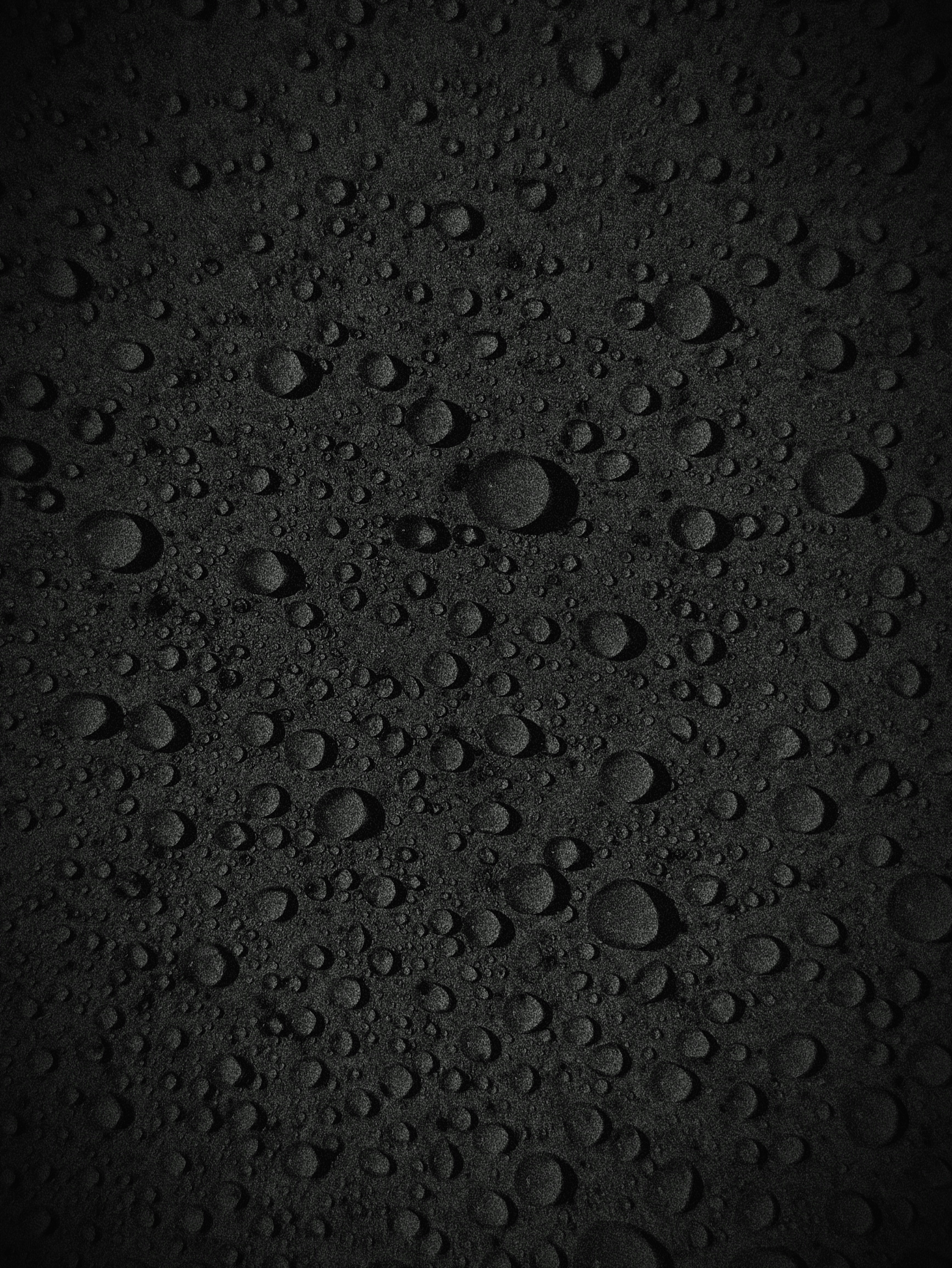 A black background with lots of water droplets