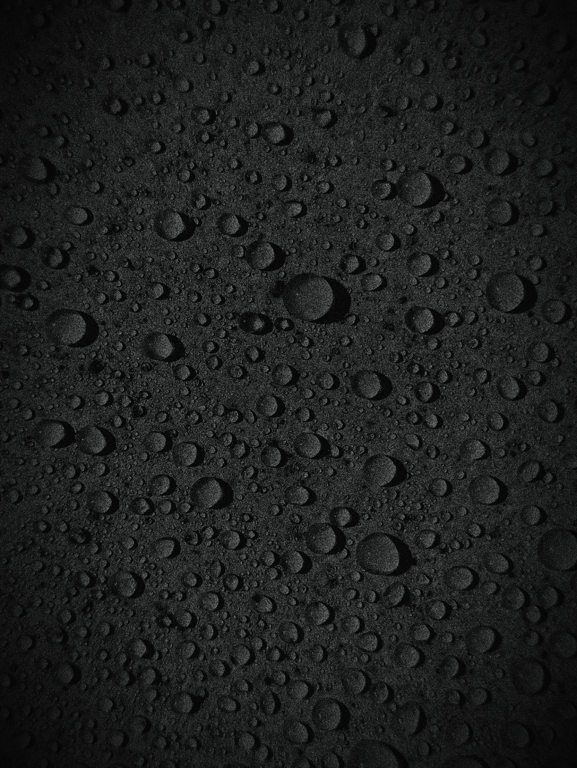 A black background with lots of water droplets