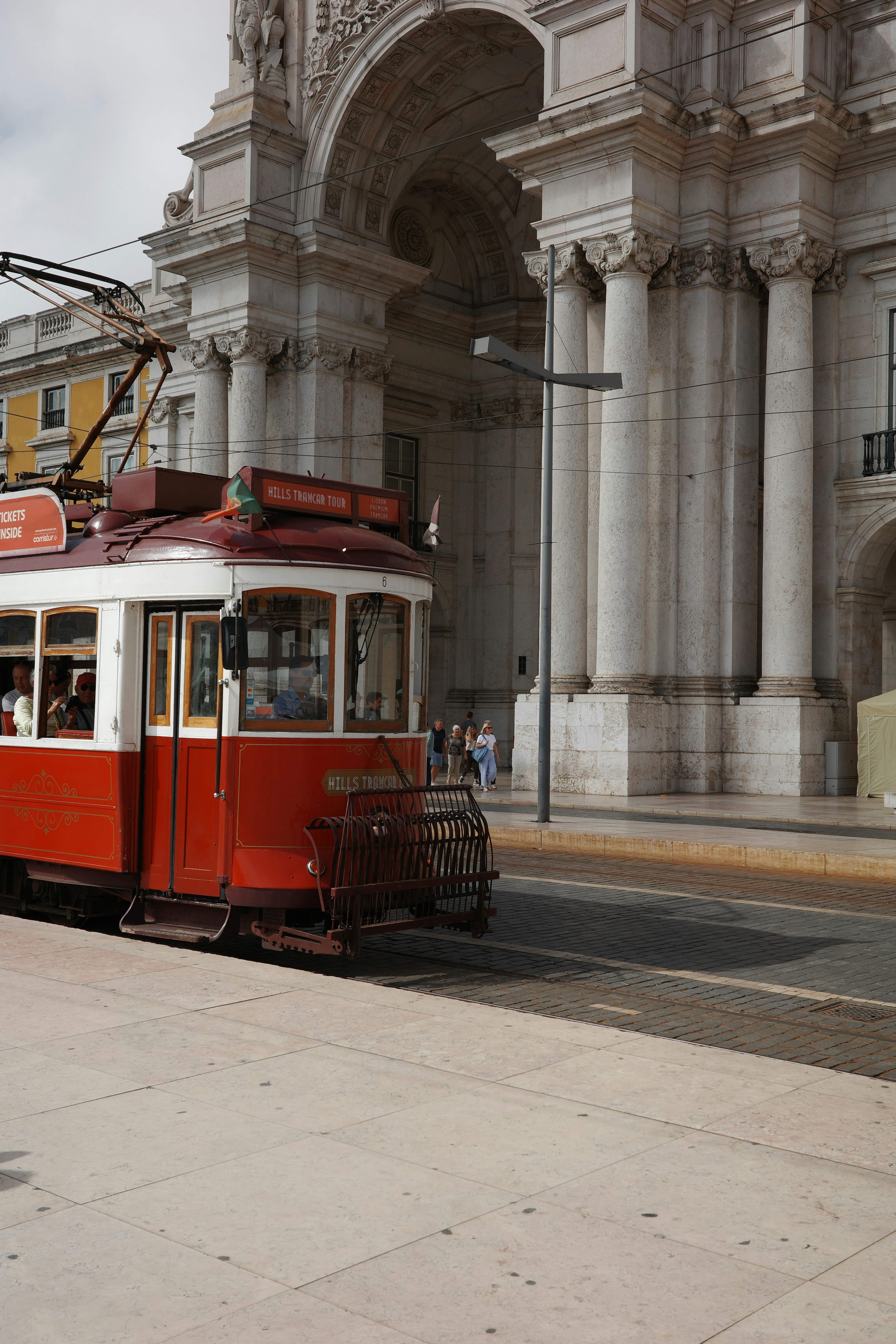 A red and white trolley on a city street
