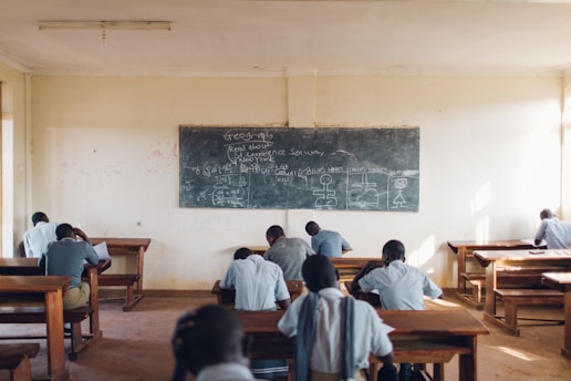 A group of people sitting at desks in a classroom