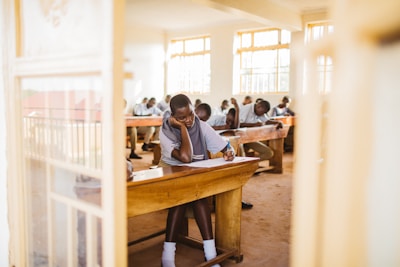 A group of people sitting at desks in a classroom