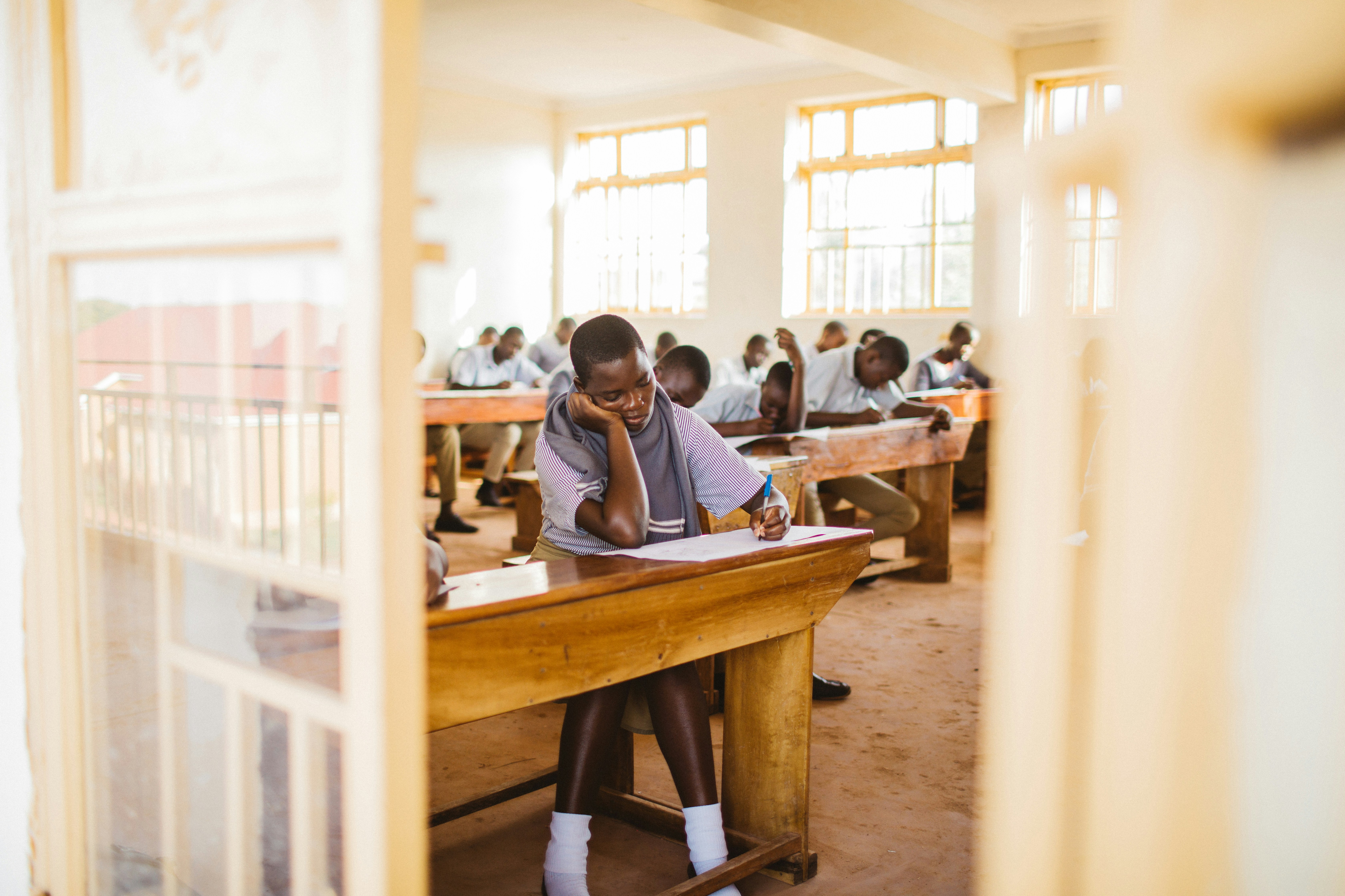 A group of people sitting at desks in a classroom
