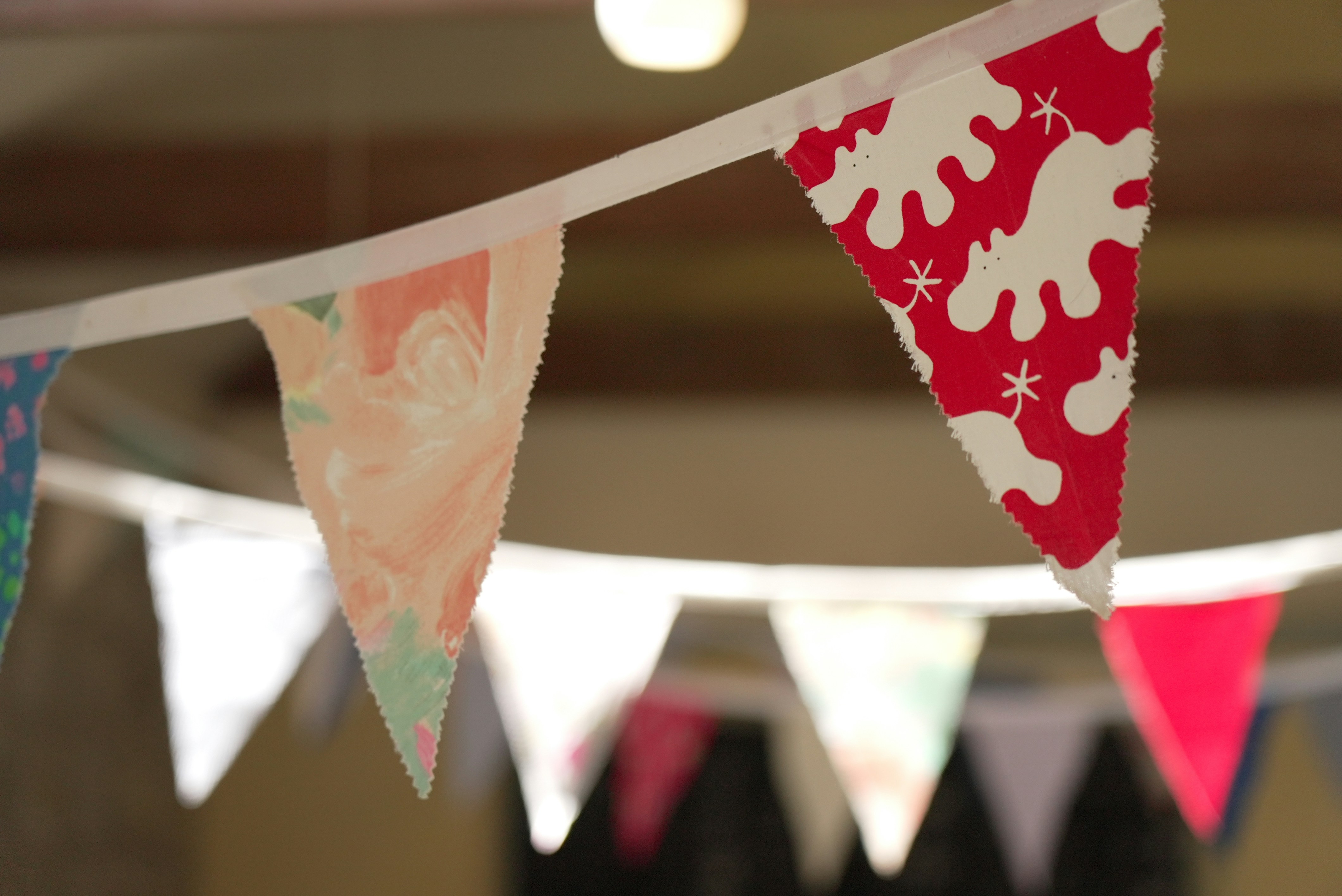 A group of flags hanging from a ceiling