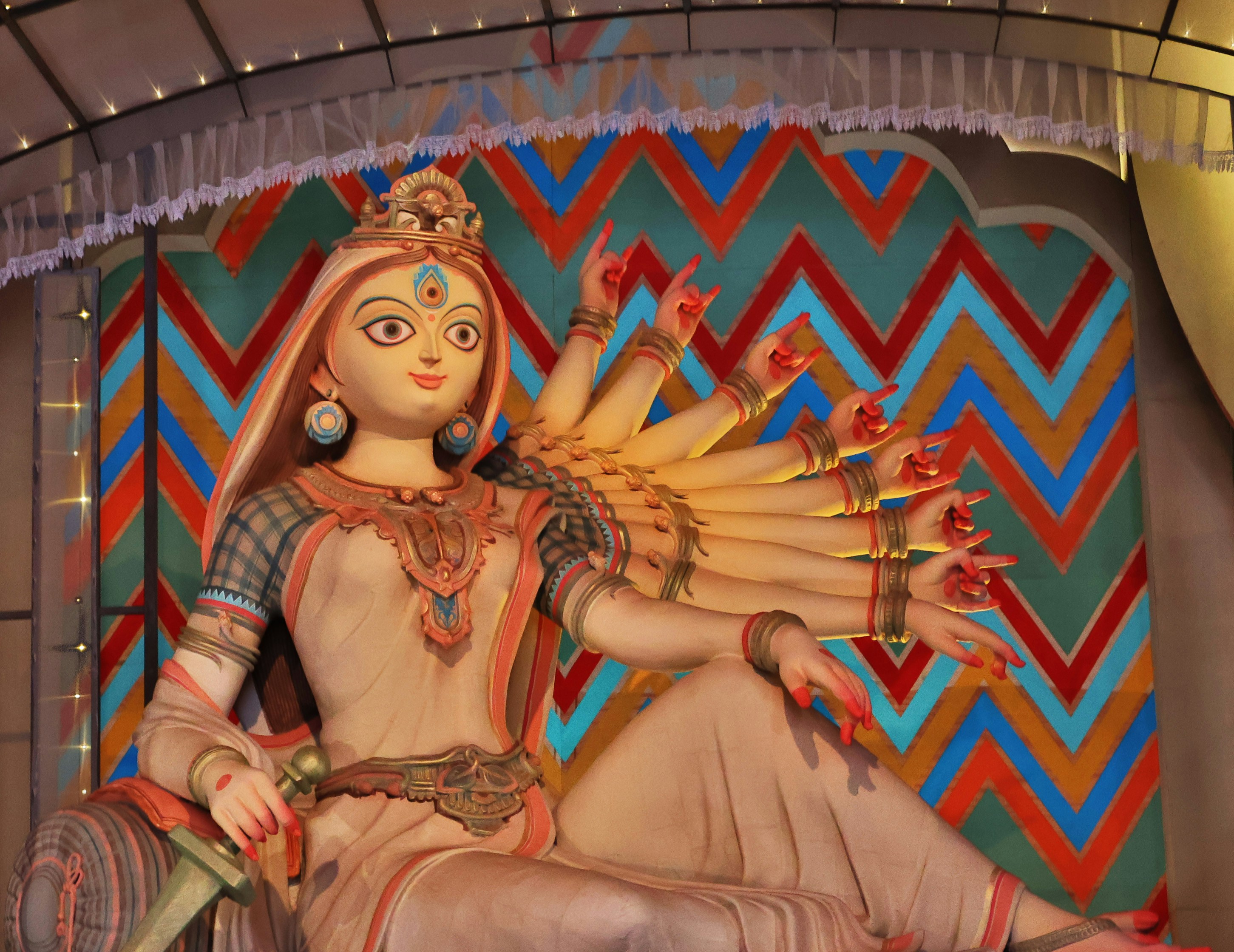 A statue of a woman sitting on top of a chair