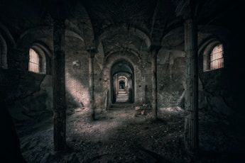 A dark tunnel with a person standing in it