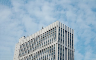 A tall white building with a sky background