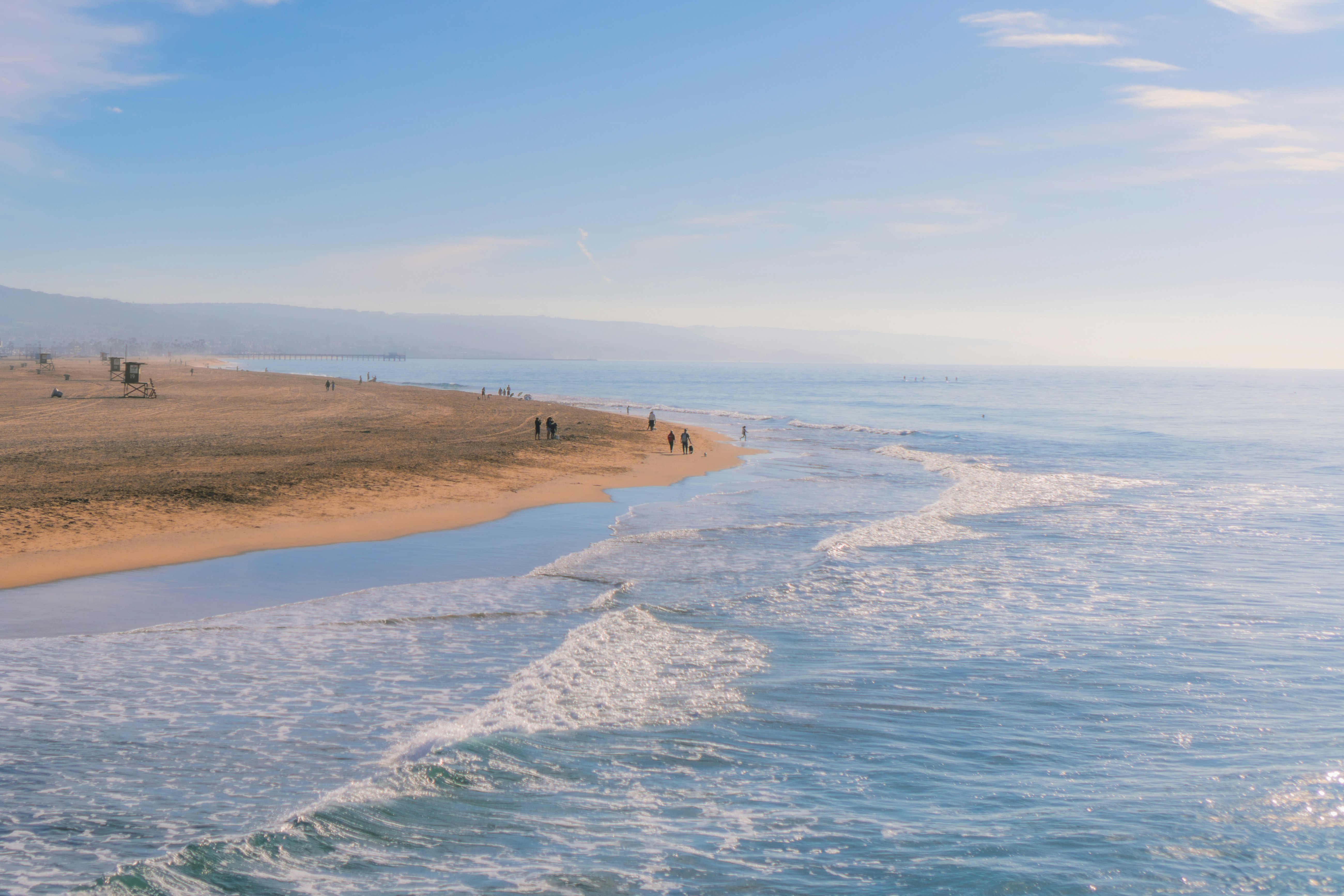 A view of a beach from a boat on the water, 
