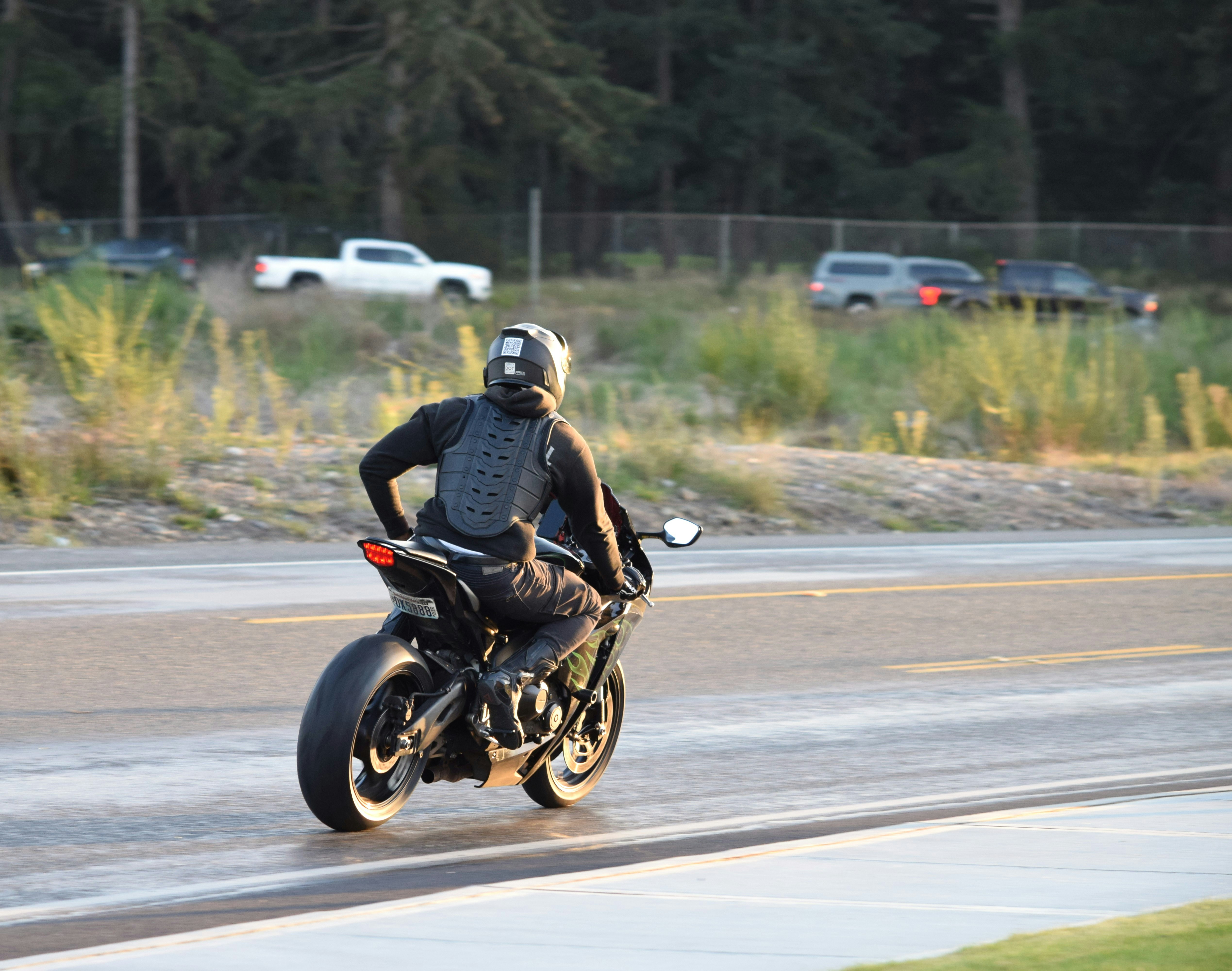 A man riding a motorcycle down a street