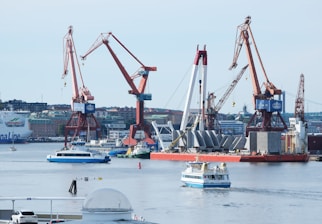 A harbor filled with lots of boats and cranes
