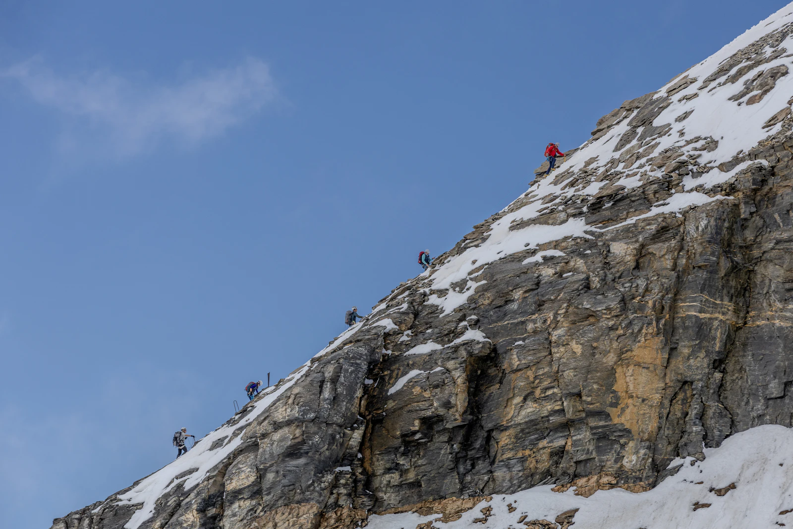 Group of trekkers standing on a snow covered high altitude mountain