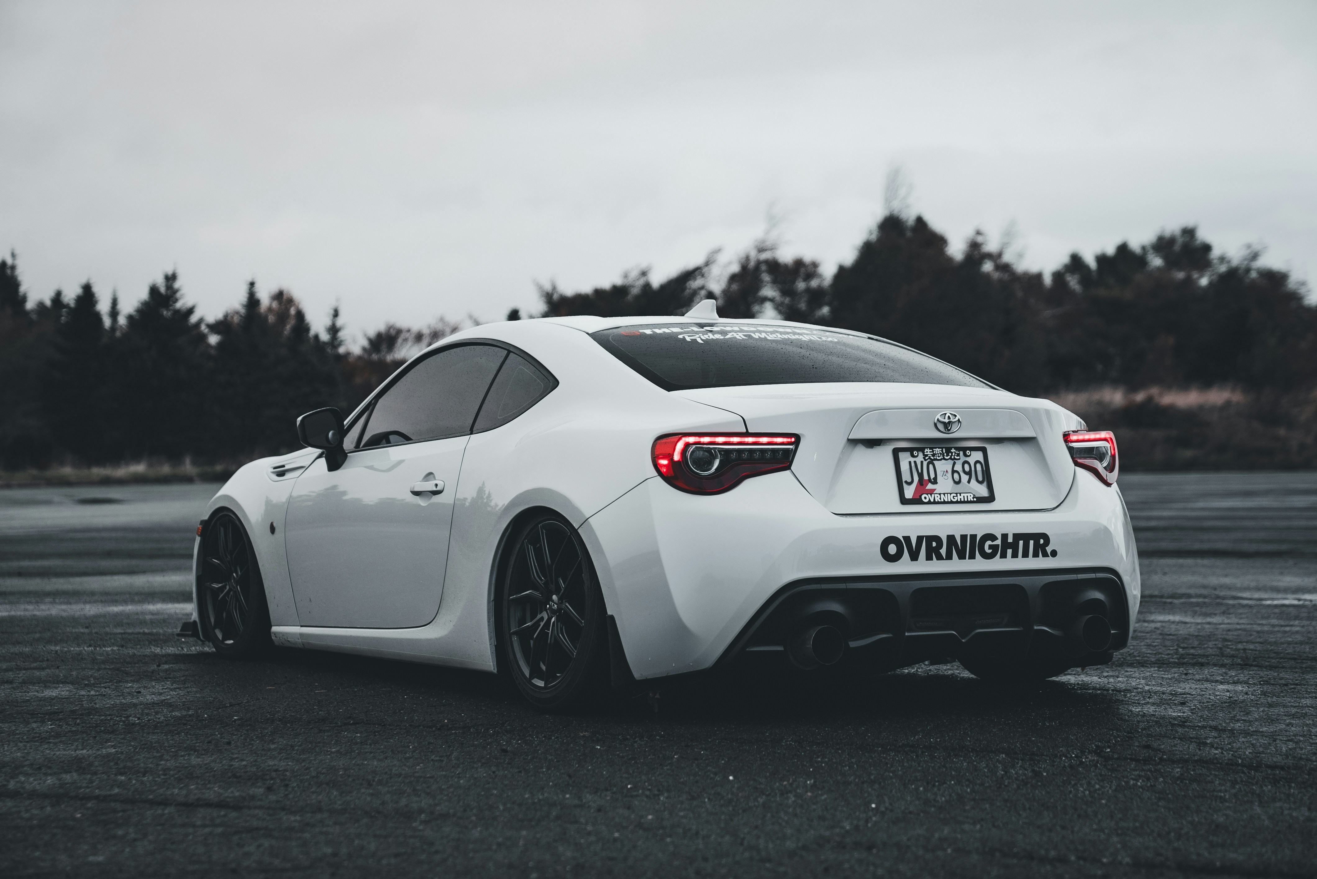 A white sports car parked in a parking lot