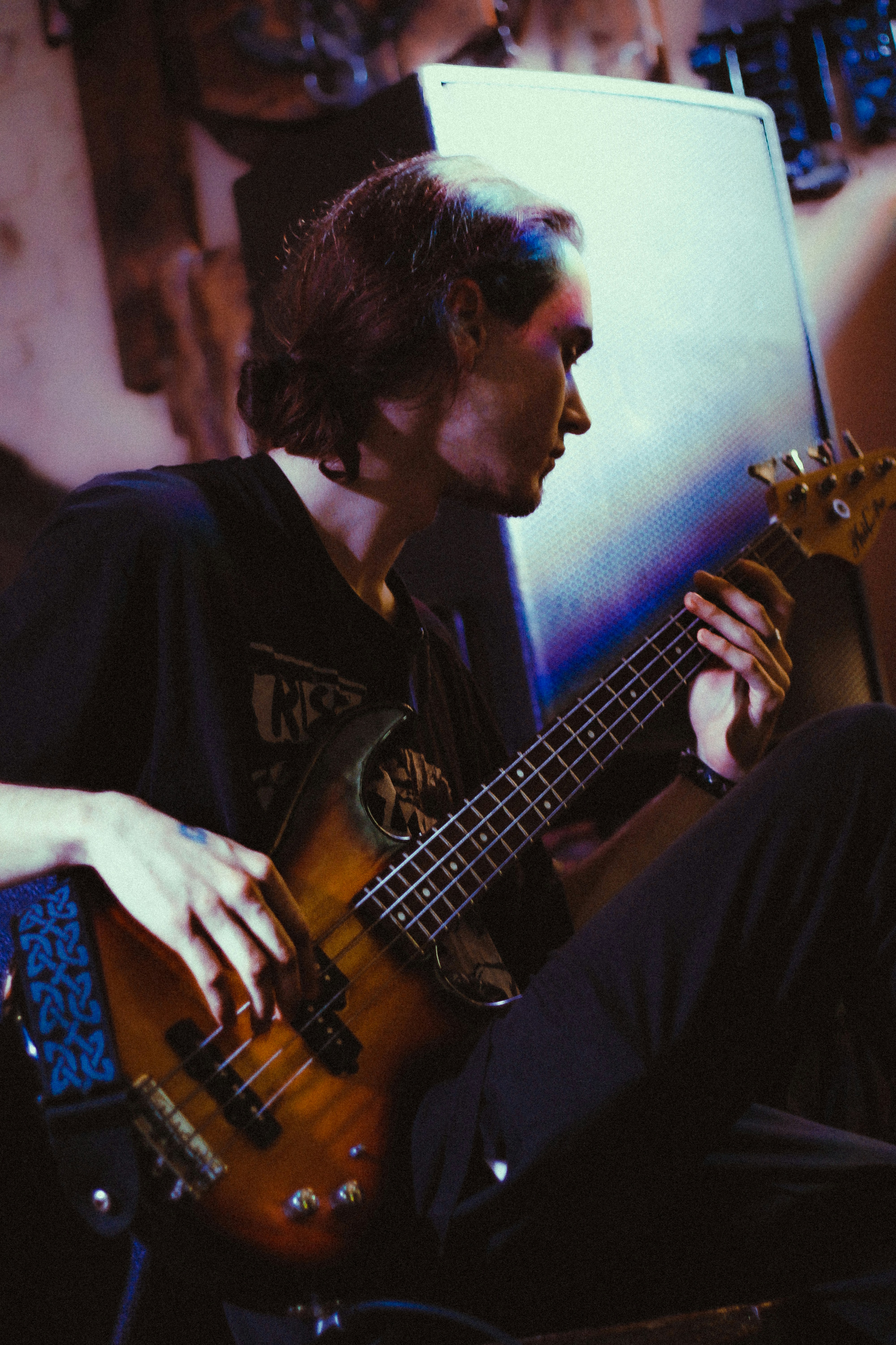 A man sitting on a chair playing a guitar photo – Free Woman Image on ...