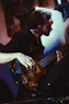 A man playing a bass guitar in a room