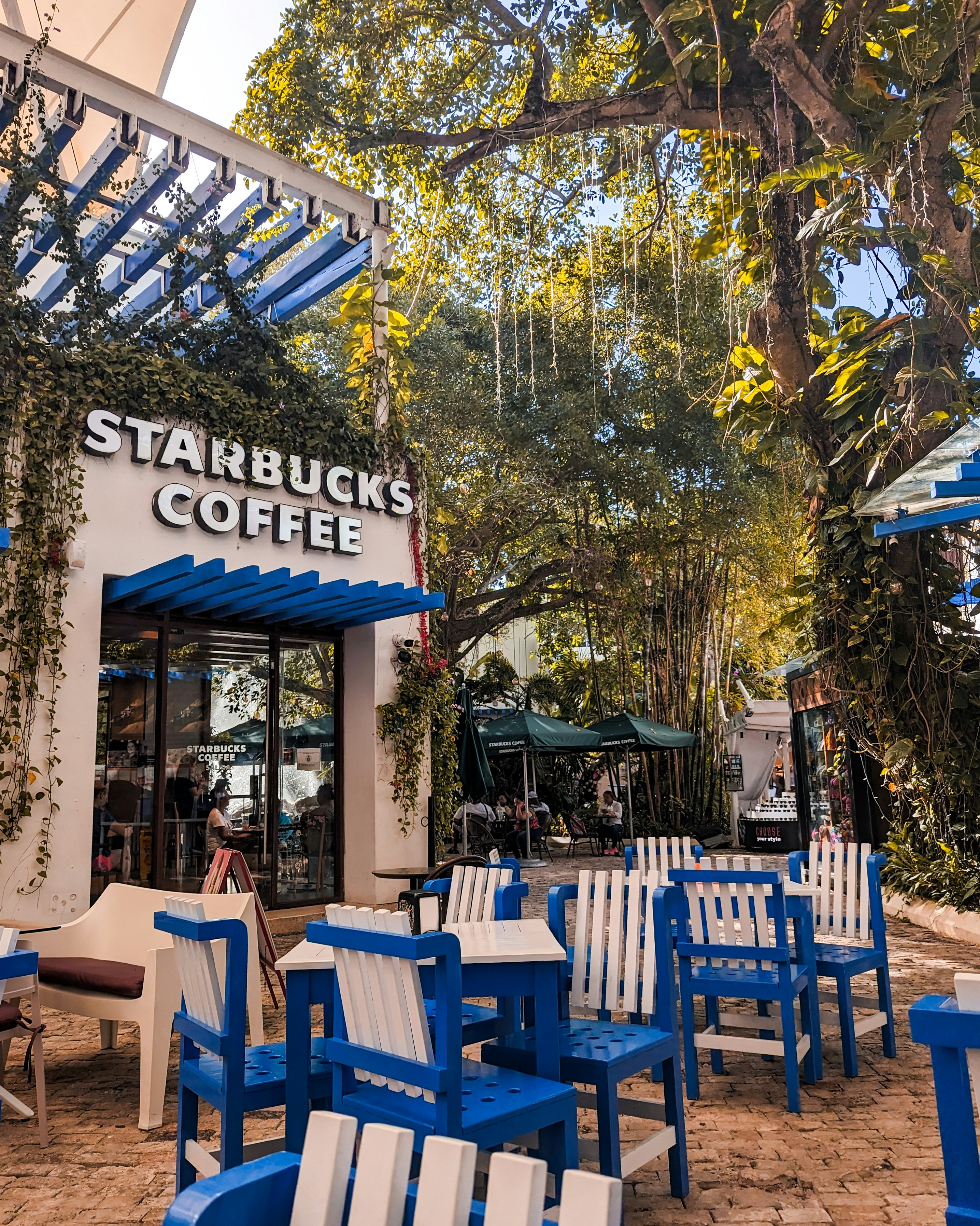 A restaurant with blue and white chairs and tables
