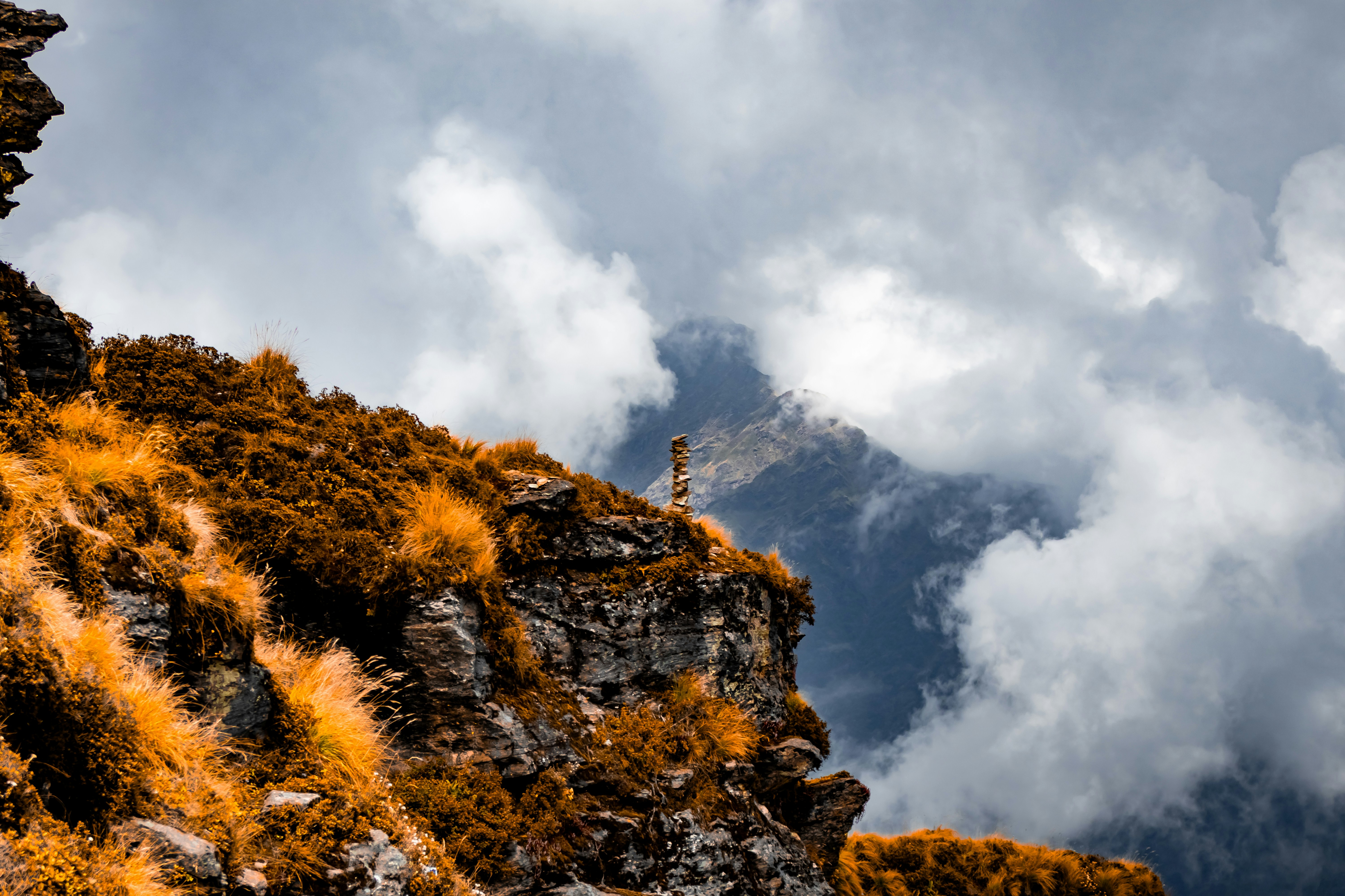 A view of a mountain with grass growing on it