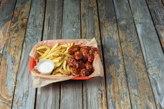 A basket of food sitting on top of a wooden table