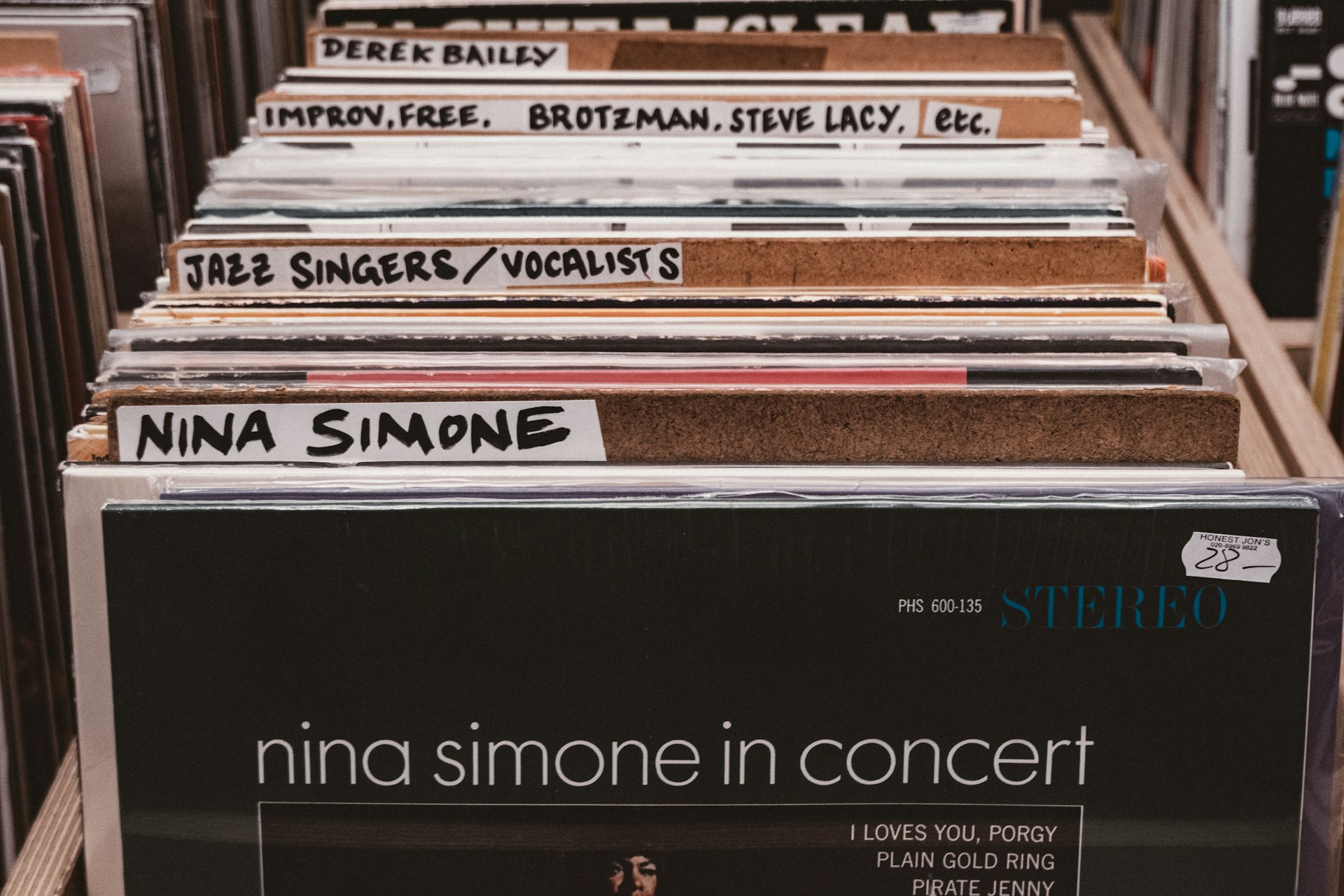 A bunch of records sitting on top of a shelf