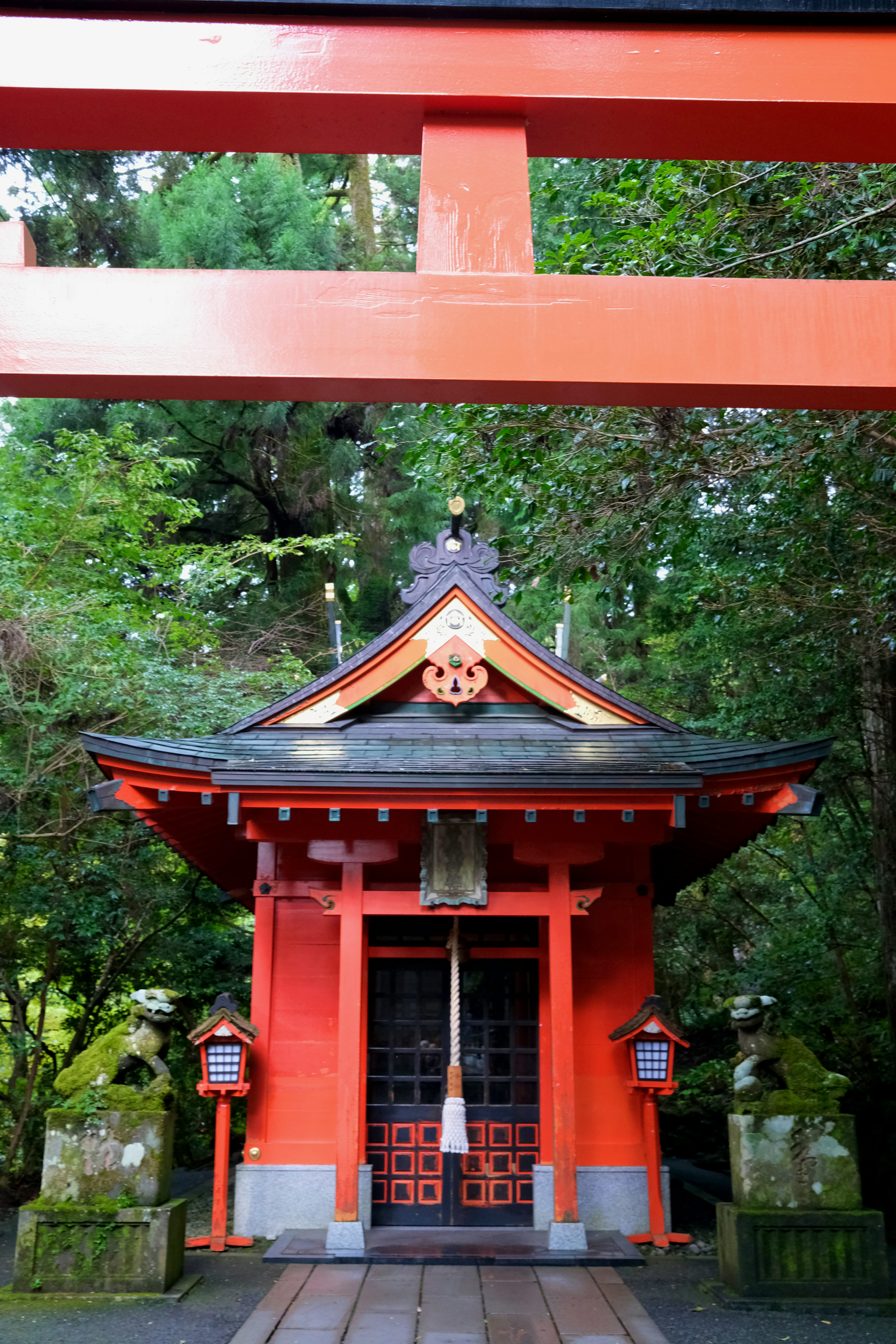 A red building with a bell on top of it