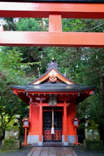 A red building with a bell on top of it