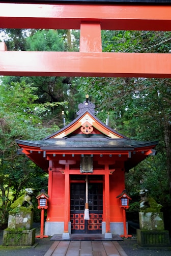 A red building with a bell on top of it
