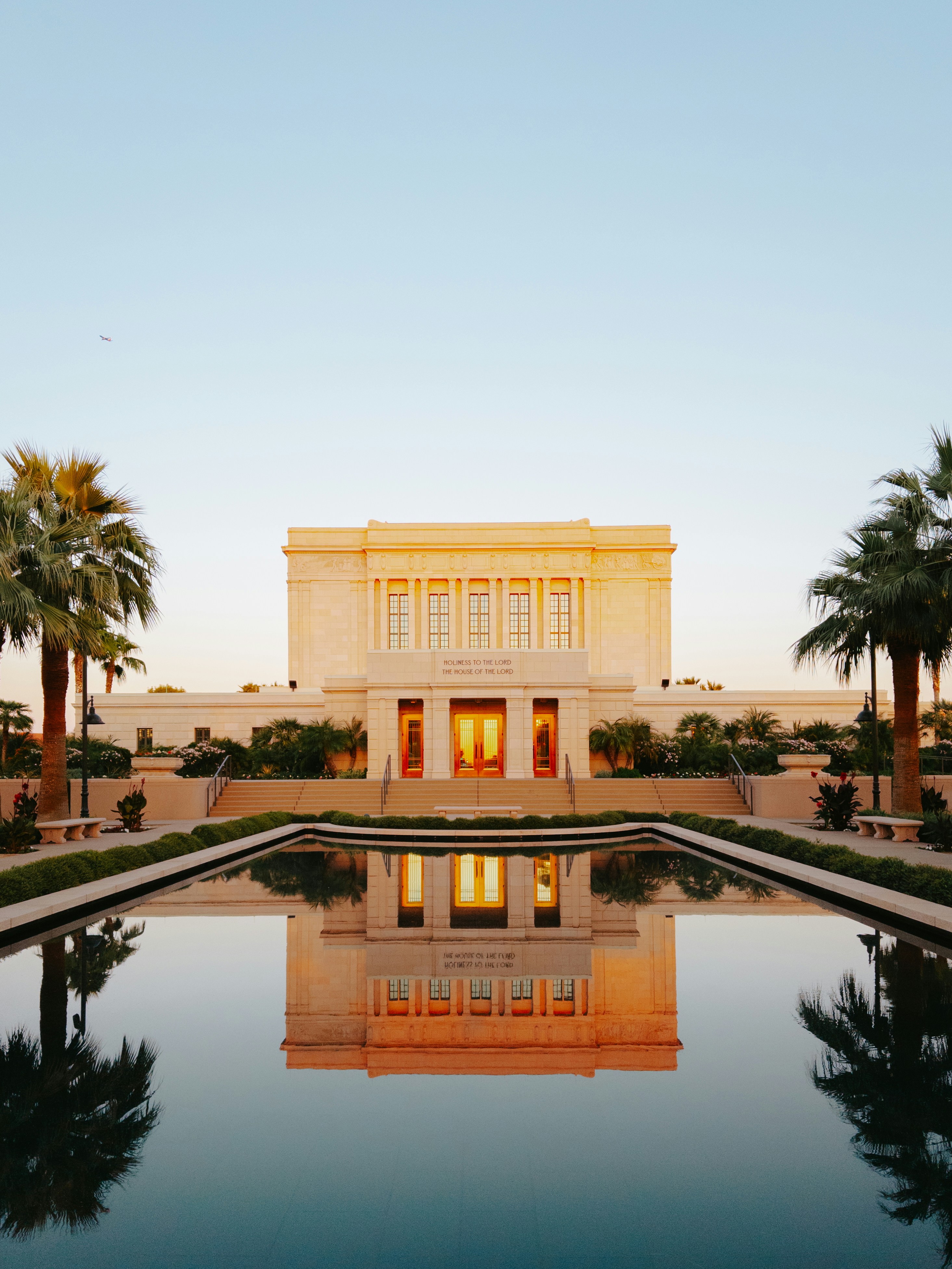 A large building with a pool in front of it