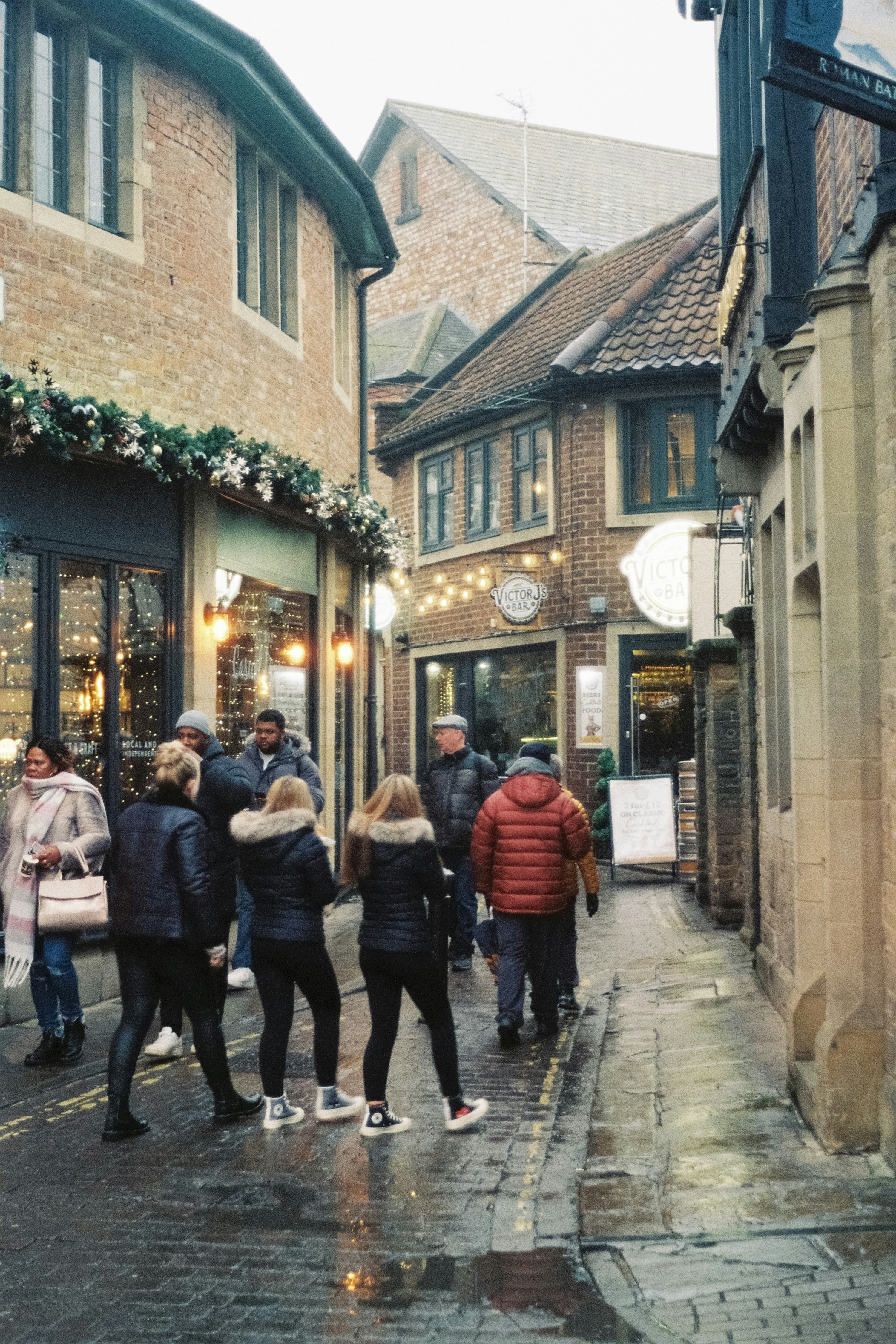 高層ビルの横の通りを歩く人々のグループ