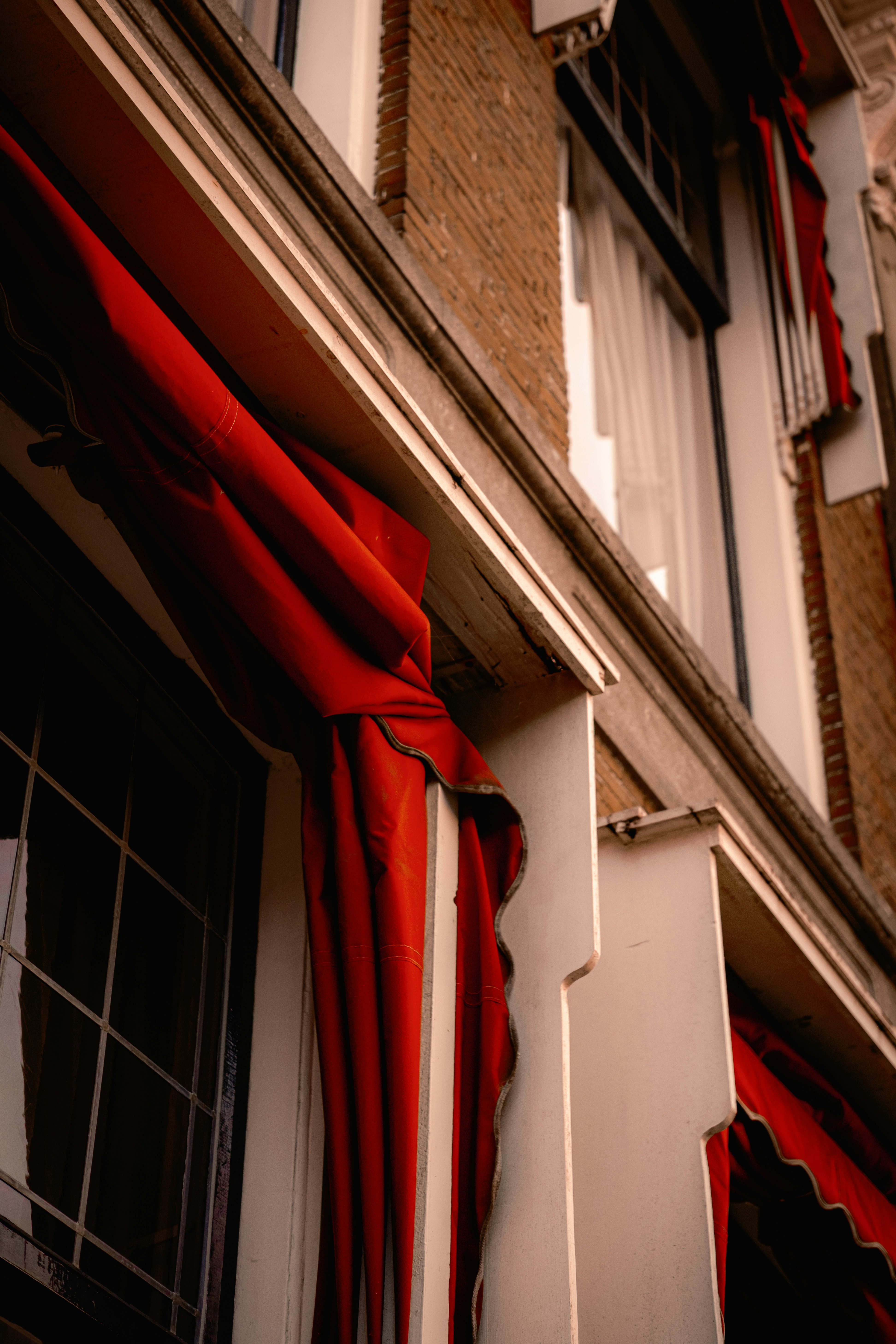 A close up of a building with a red awning